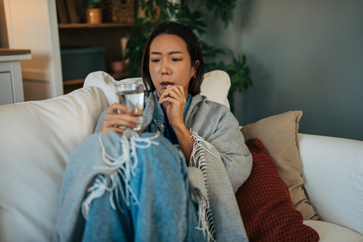 生病的女人在家吃药,<strong>感觉</strong>不适