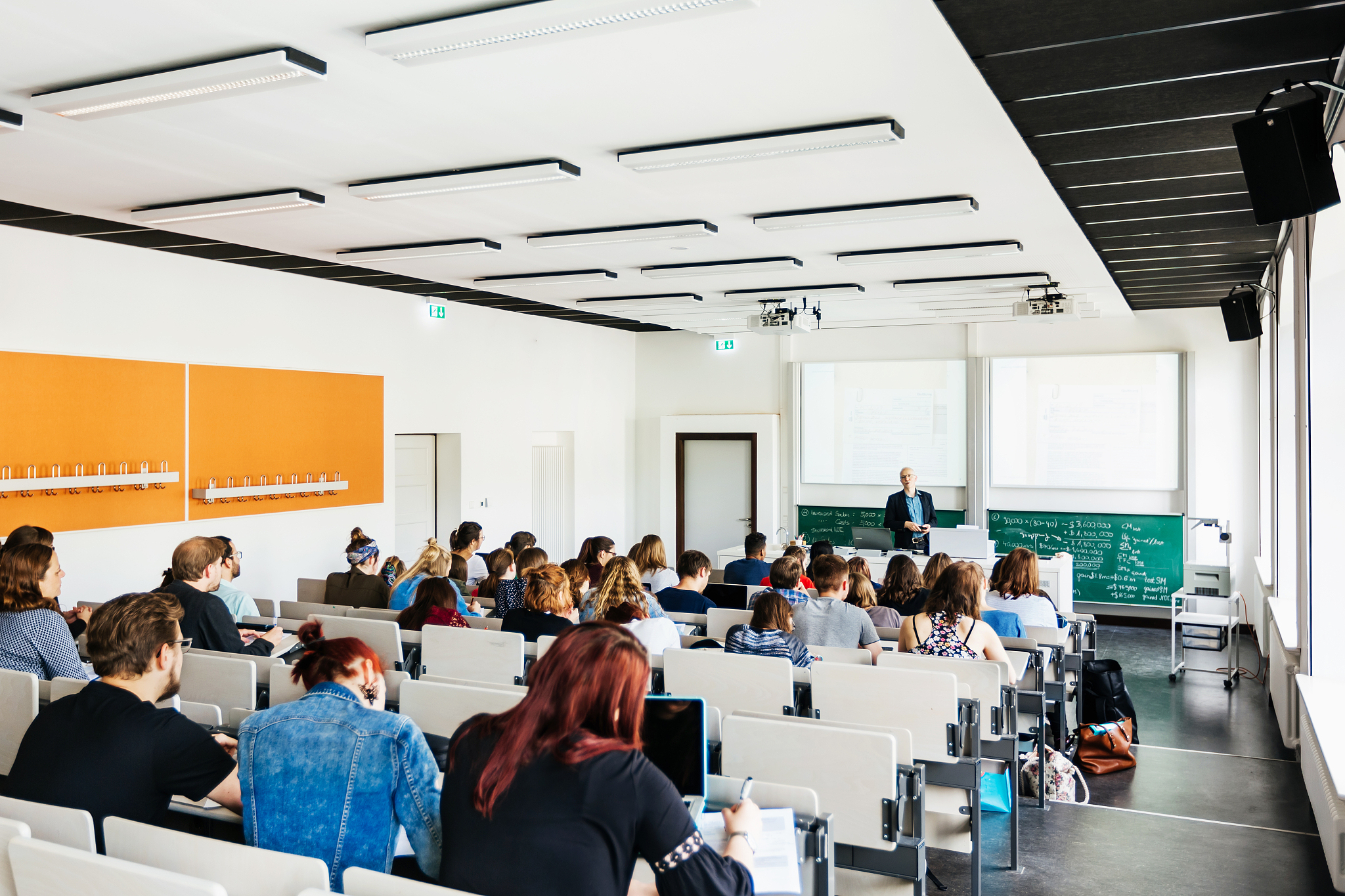 university lecturer addressing students in lecture hall