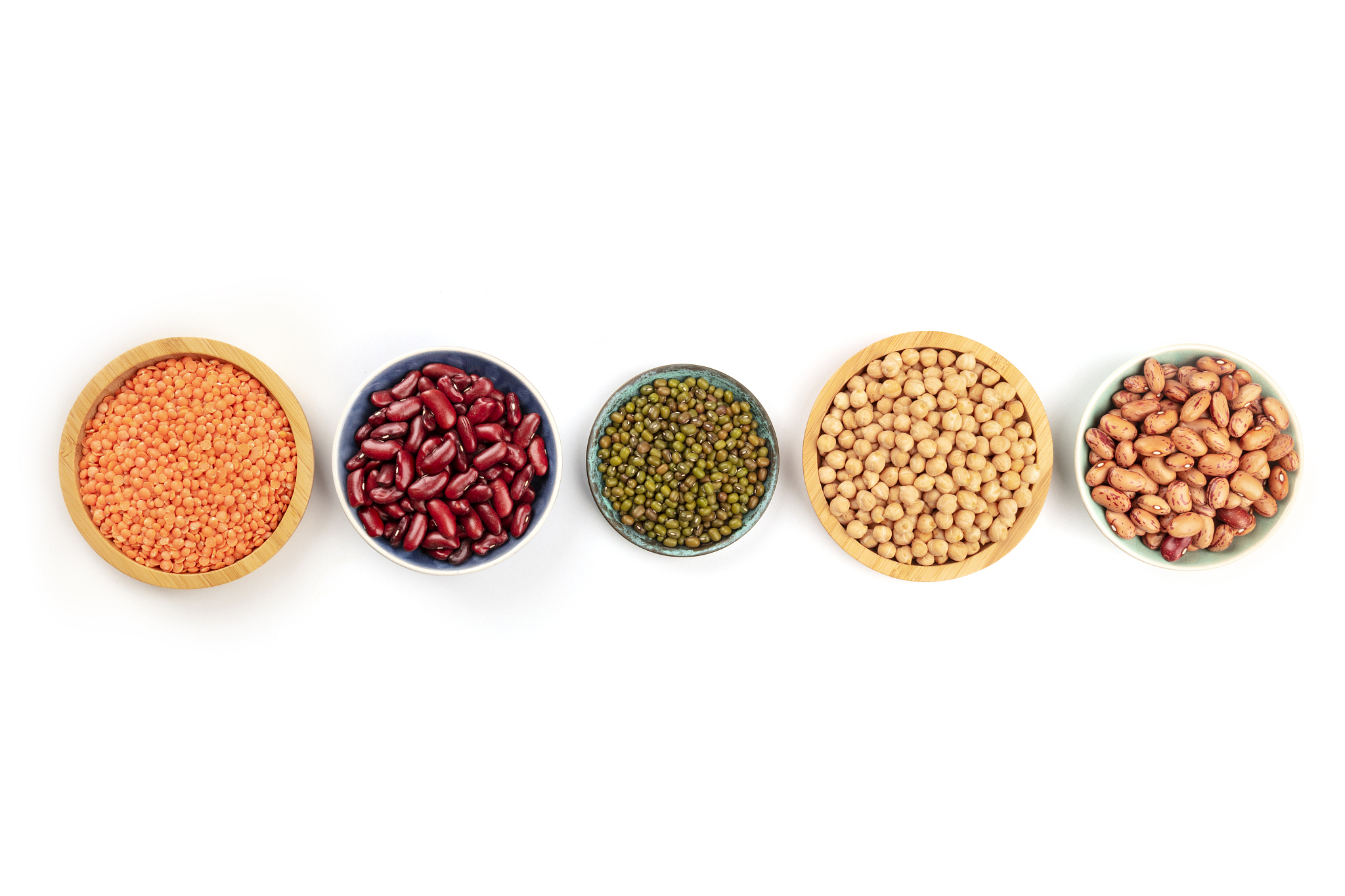 various types of legumes, shot from above on a white background 