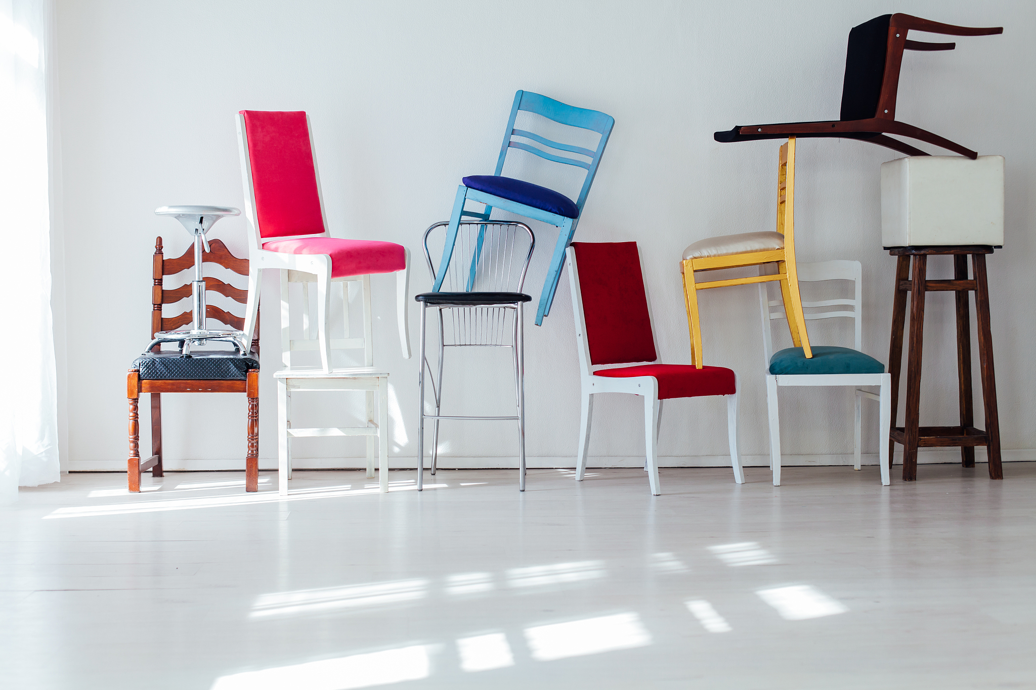 lots of different chairs in the interior of an empty office