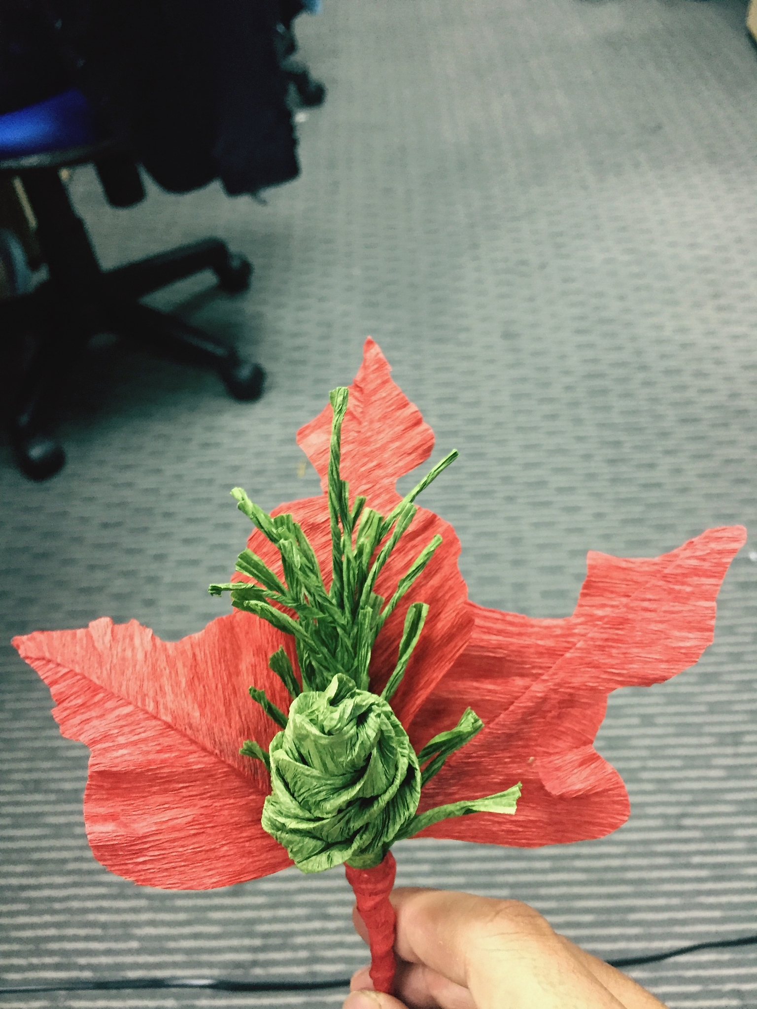 cropped hand holding artificial flower