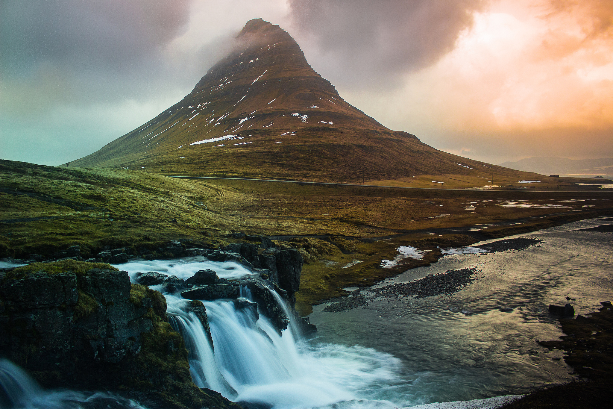 idyllic view of waterfall and mountain against cloudy sky during