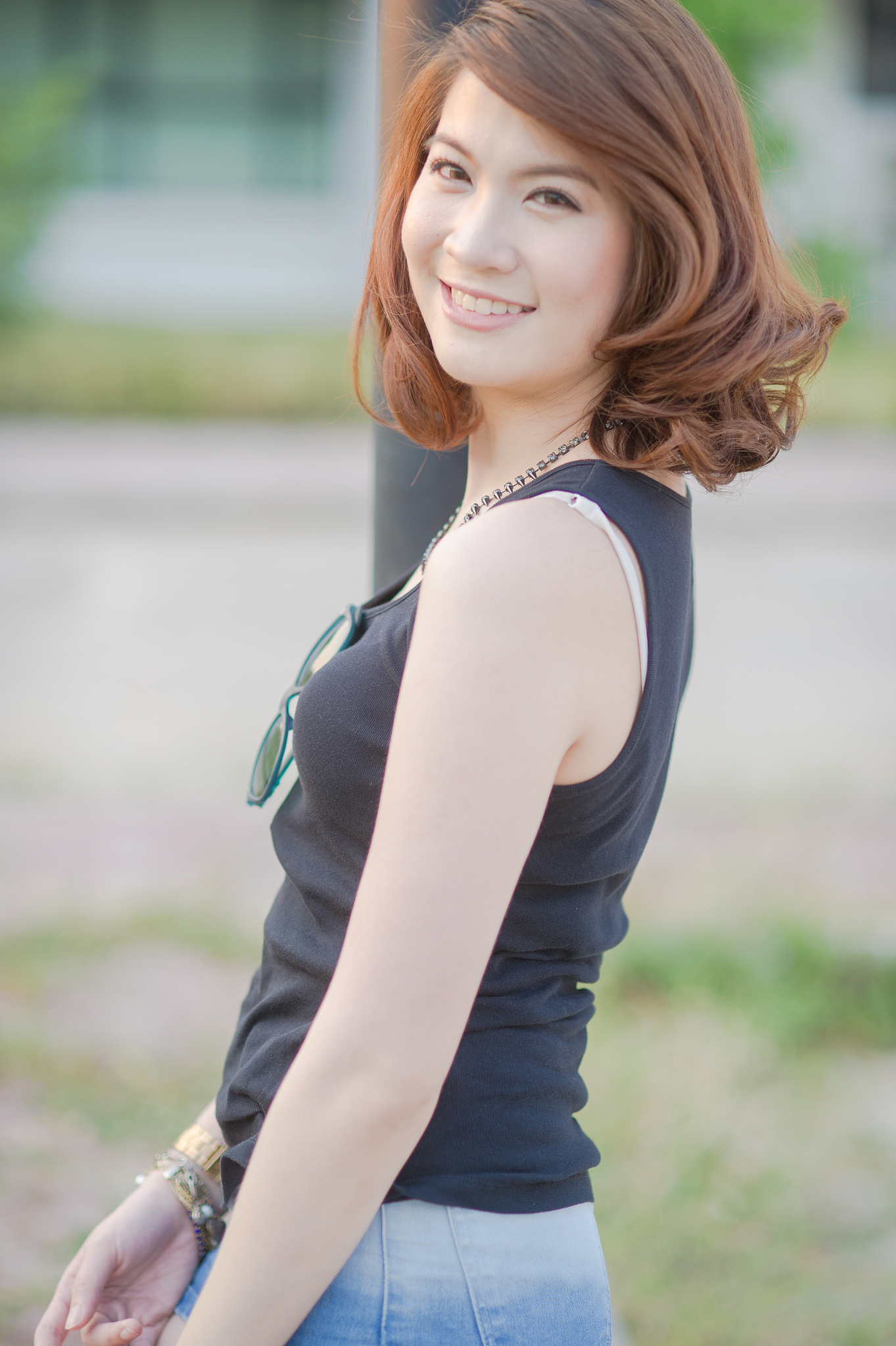 portrait of smiling woman standing against building
