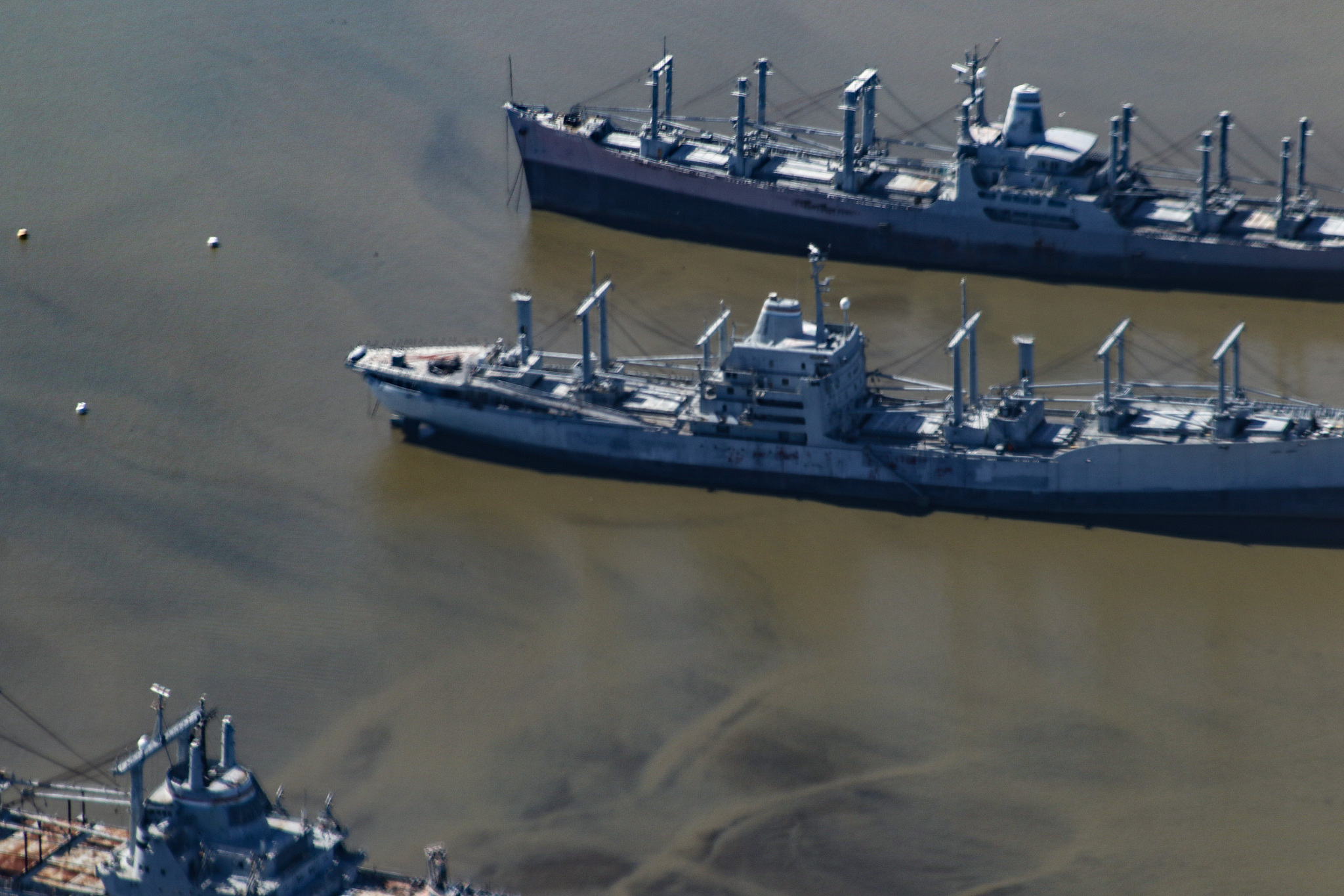 aerial view of old merchant marine vessels in a river