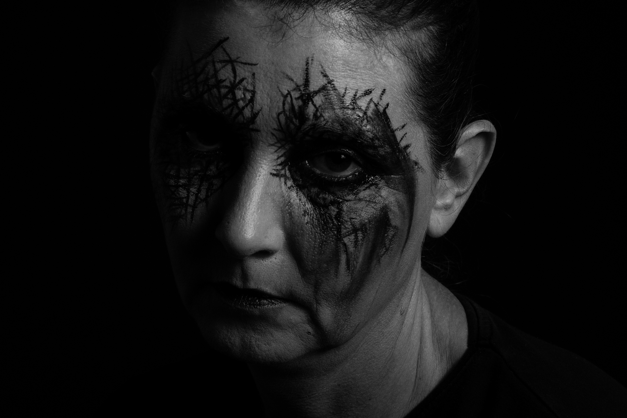 close-up portrait of woman with halloween make-up over black bac