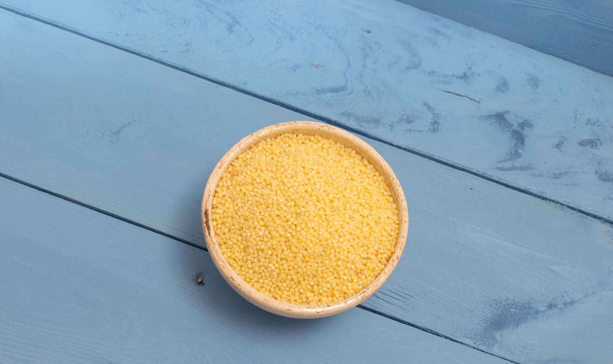 millet groats on the blue board