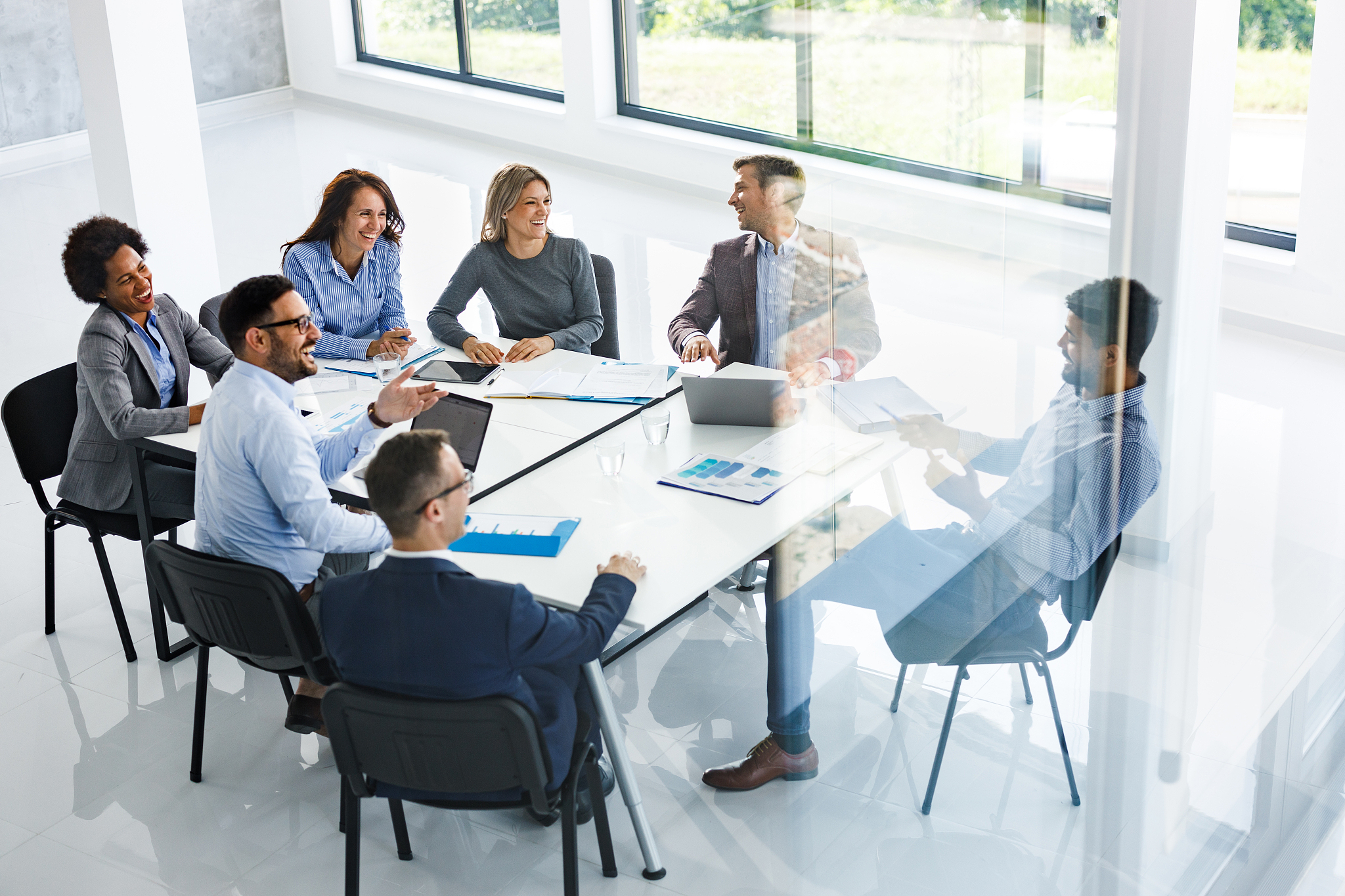 happy business colleagues talking on a meeting in board room.