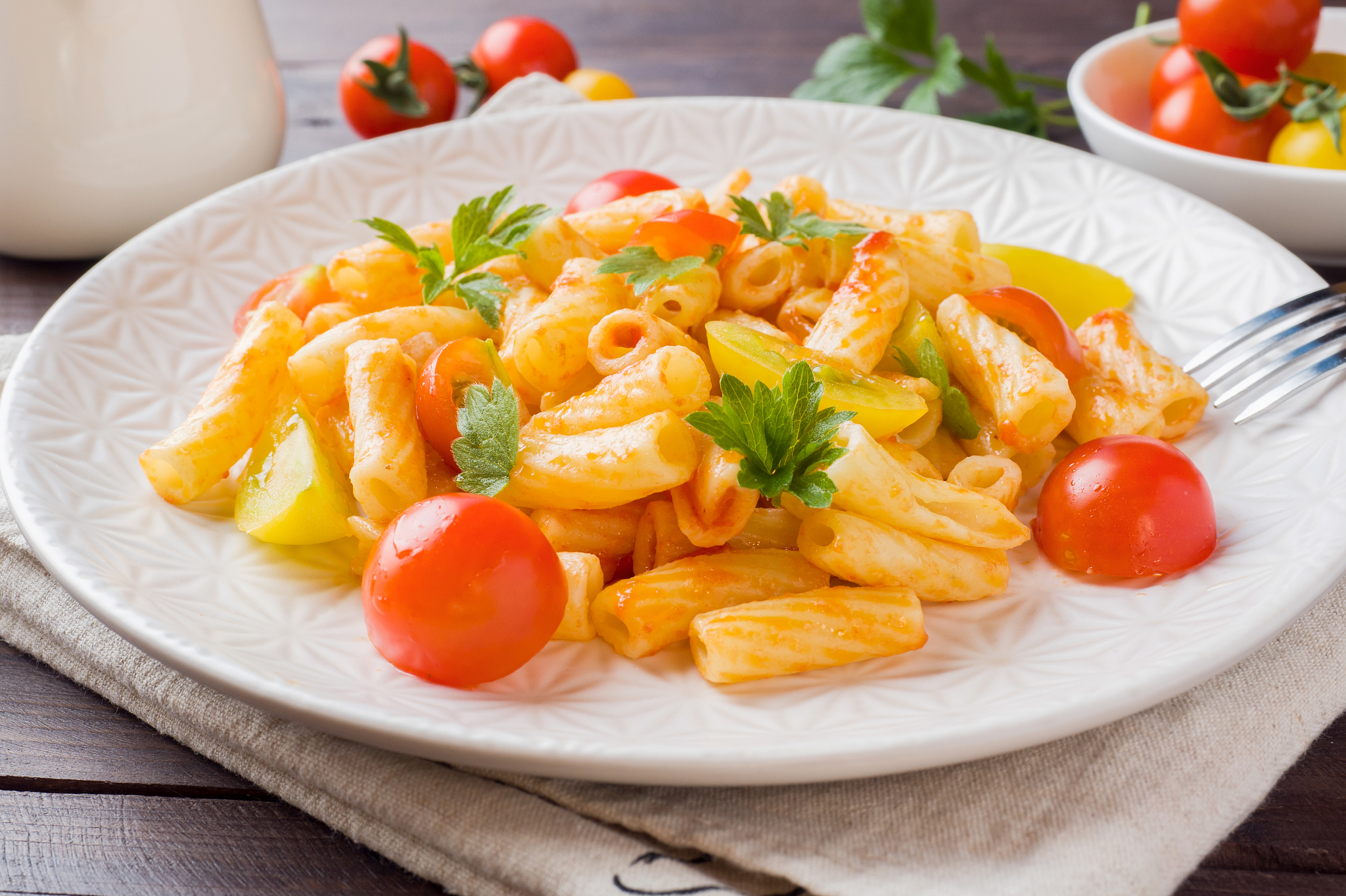 macaroni, pasta in tomato sauce and cheese in a plate on a woode