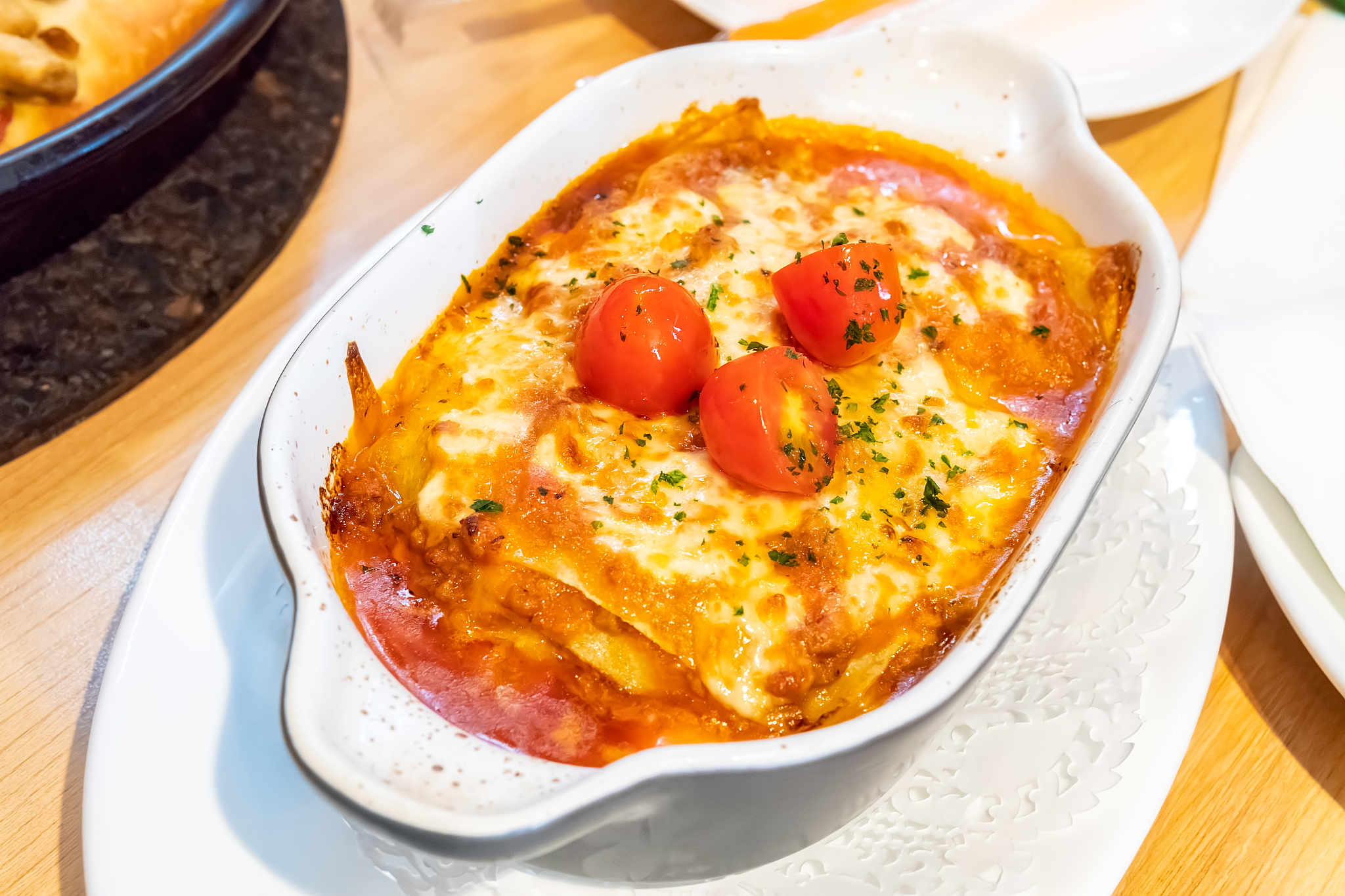 closeup image of a piece of lasagna on white plate
