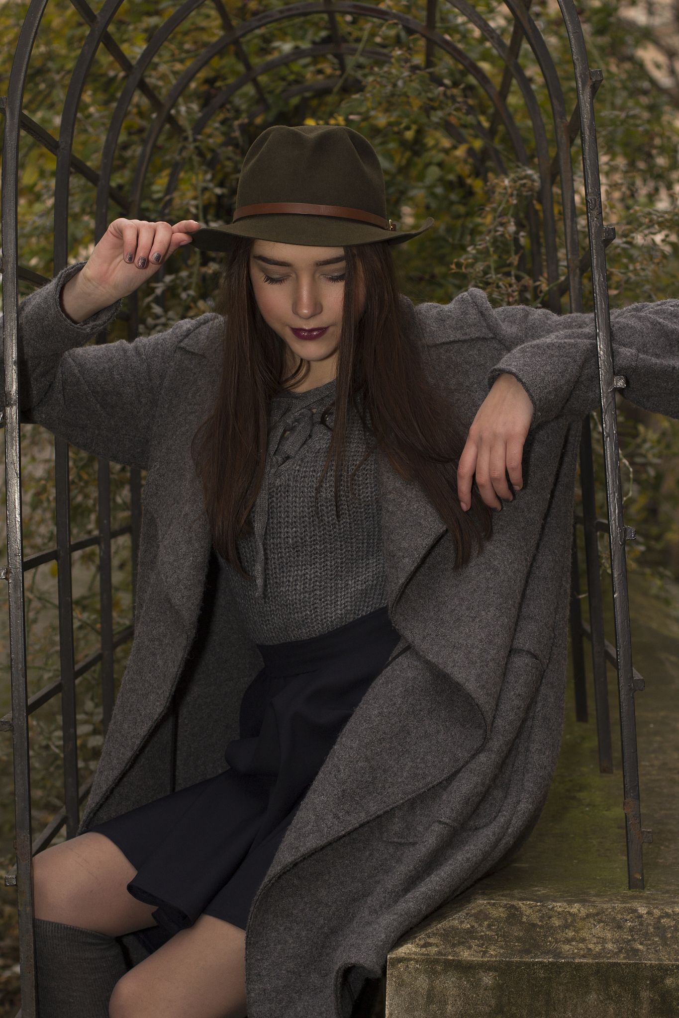lovely young woman in coat and hat at the street