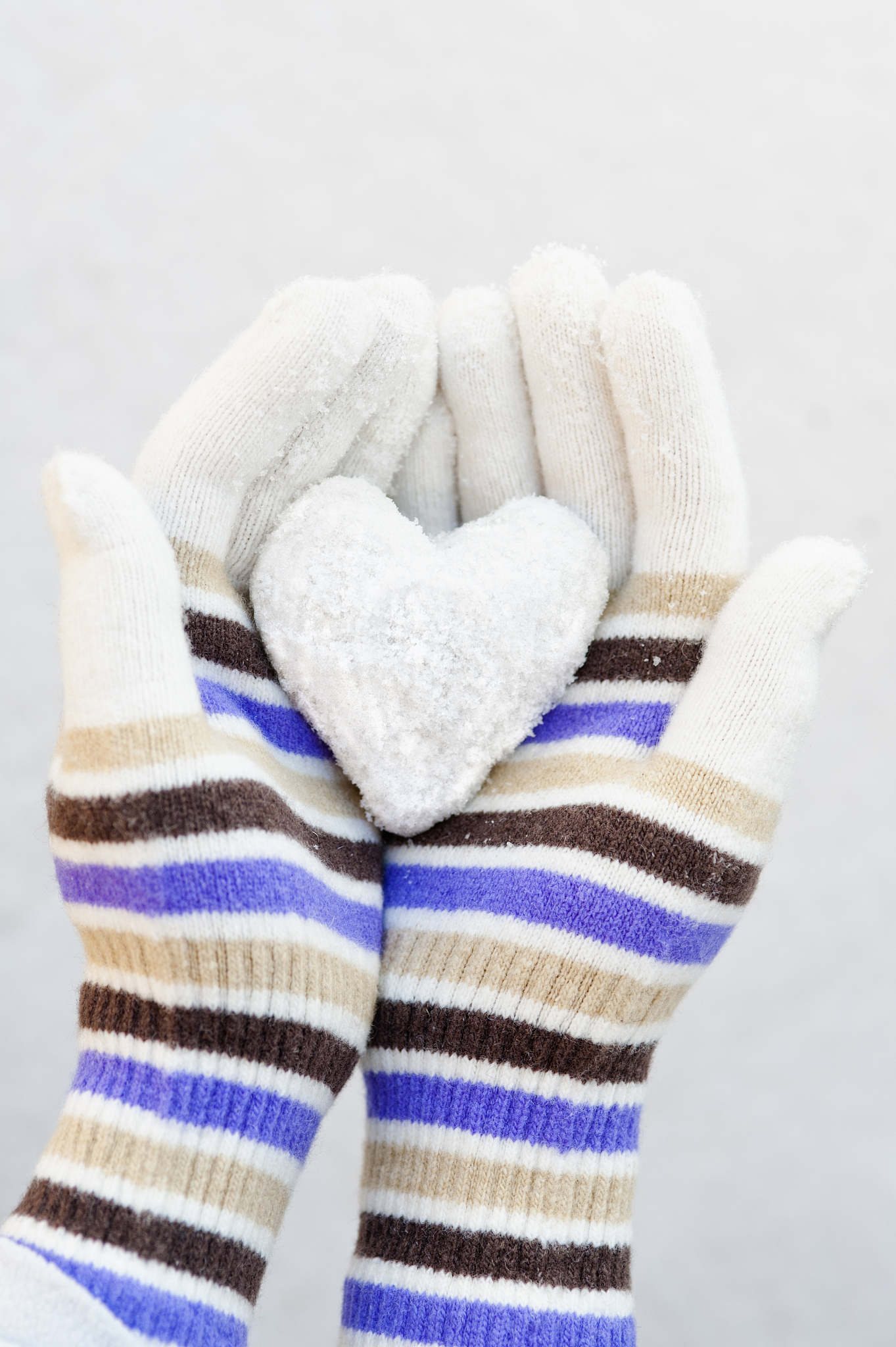woman's hands holding snowheart.