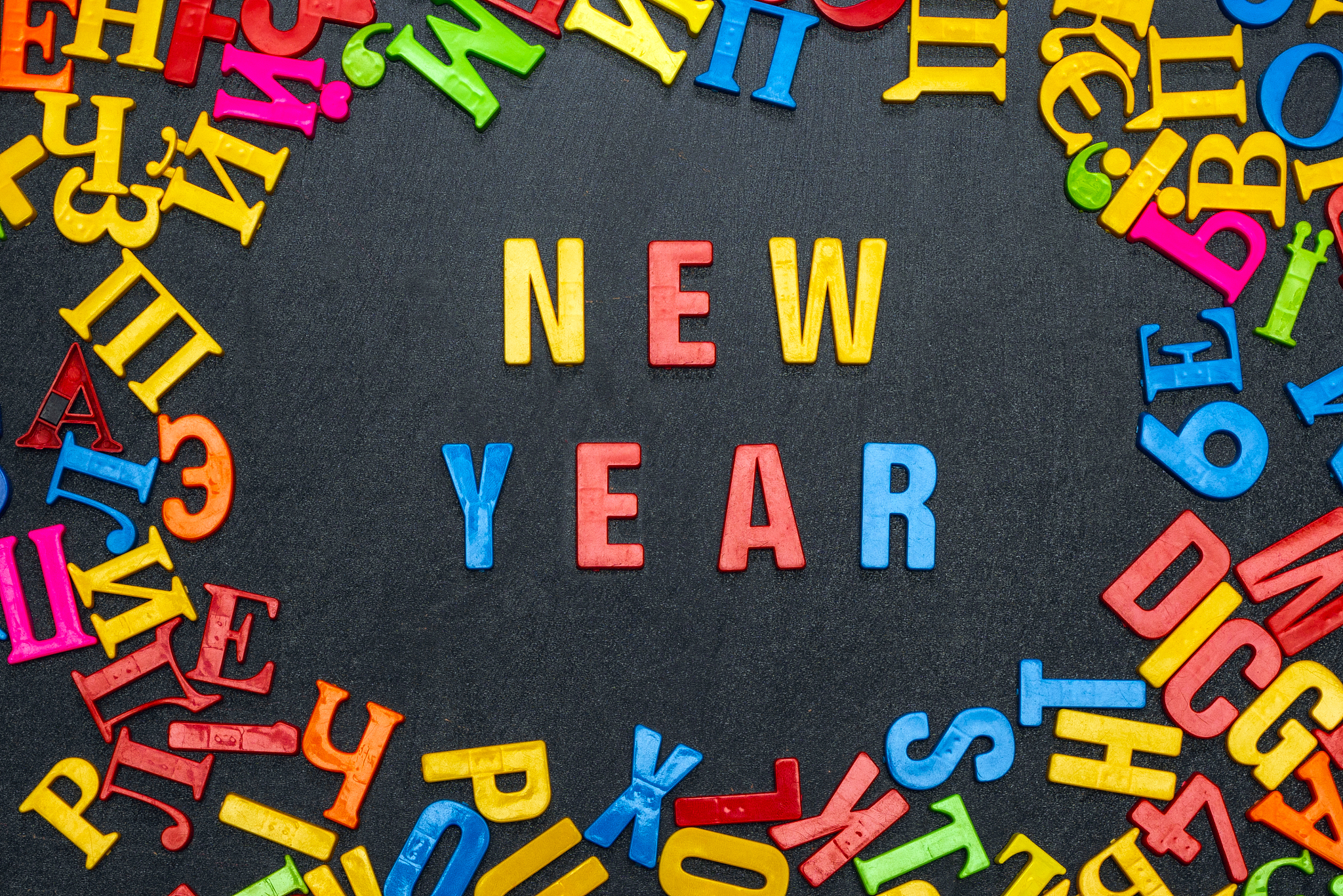 new year word from bright color letters on black background