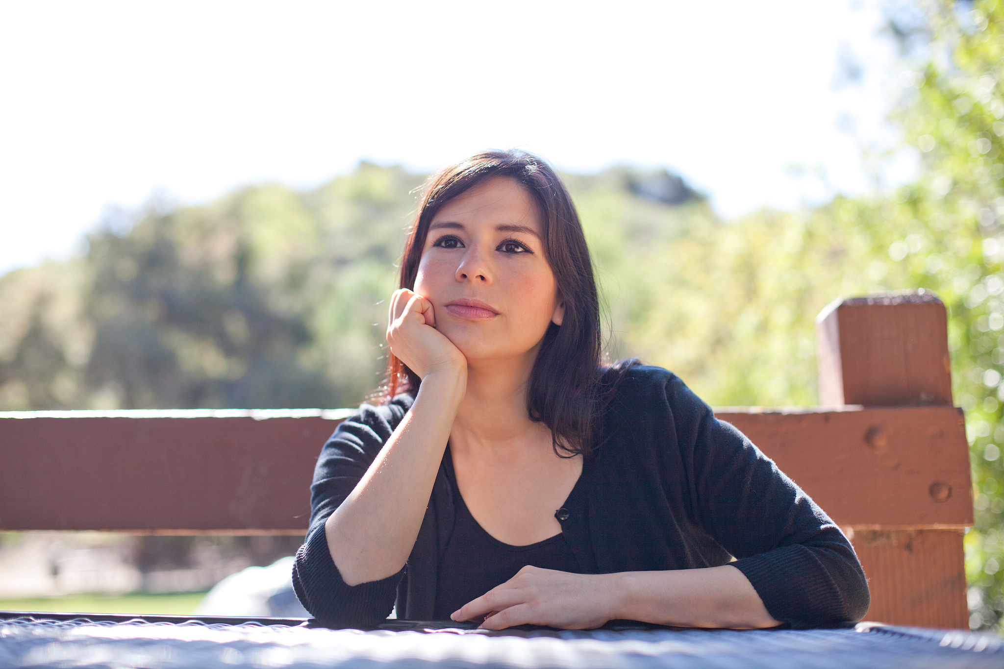 woman sitting on table at park
