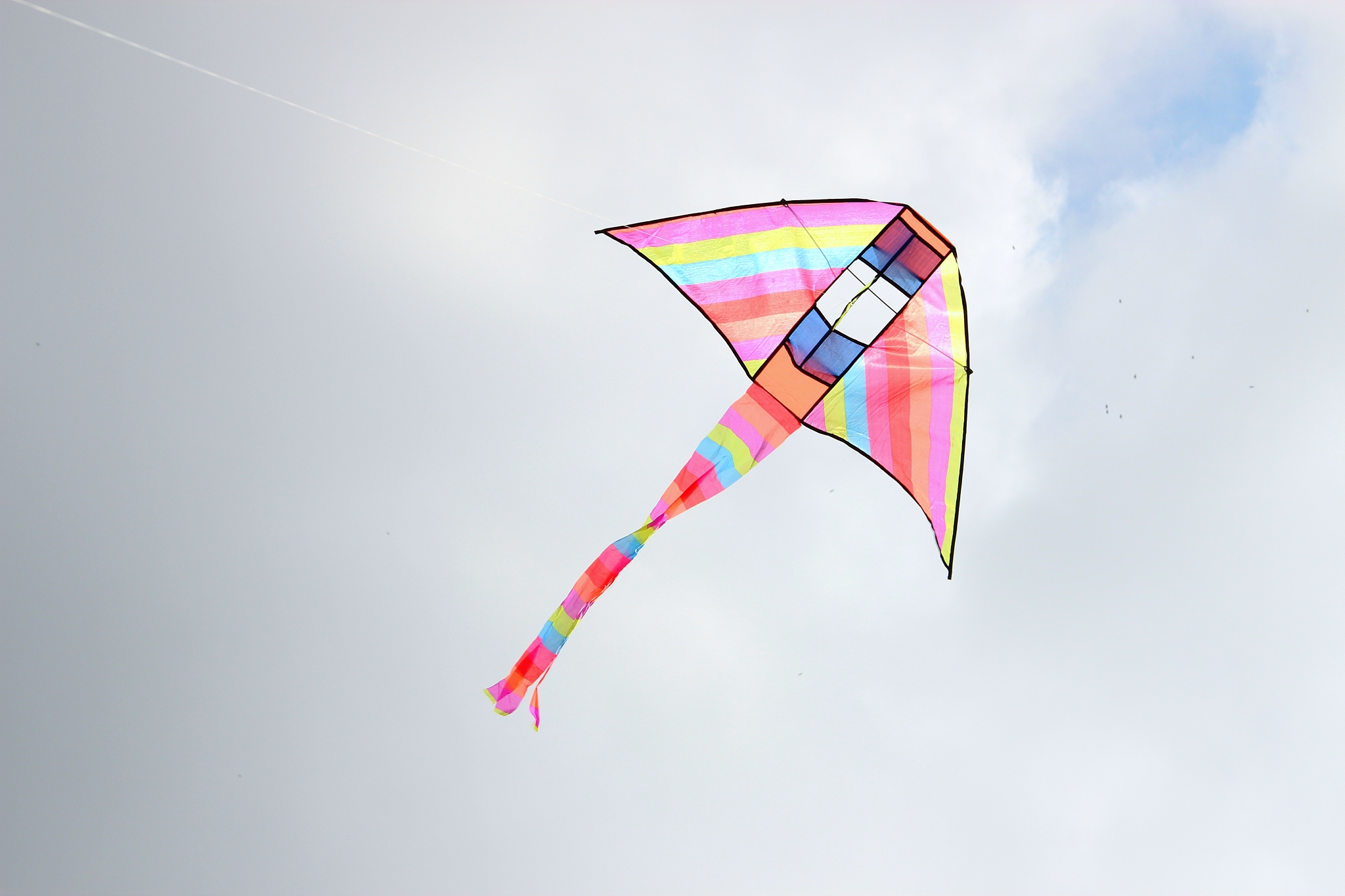 low angle view of kite flying against sky
