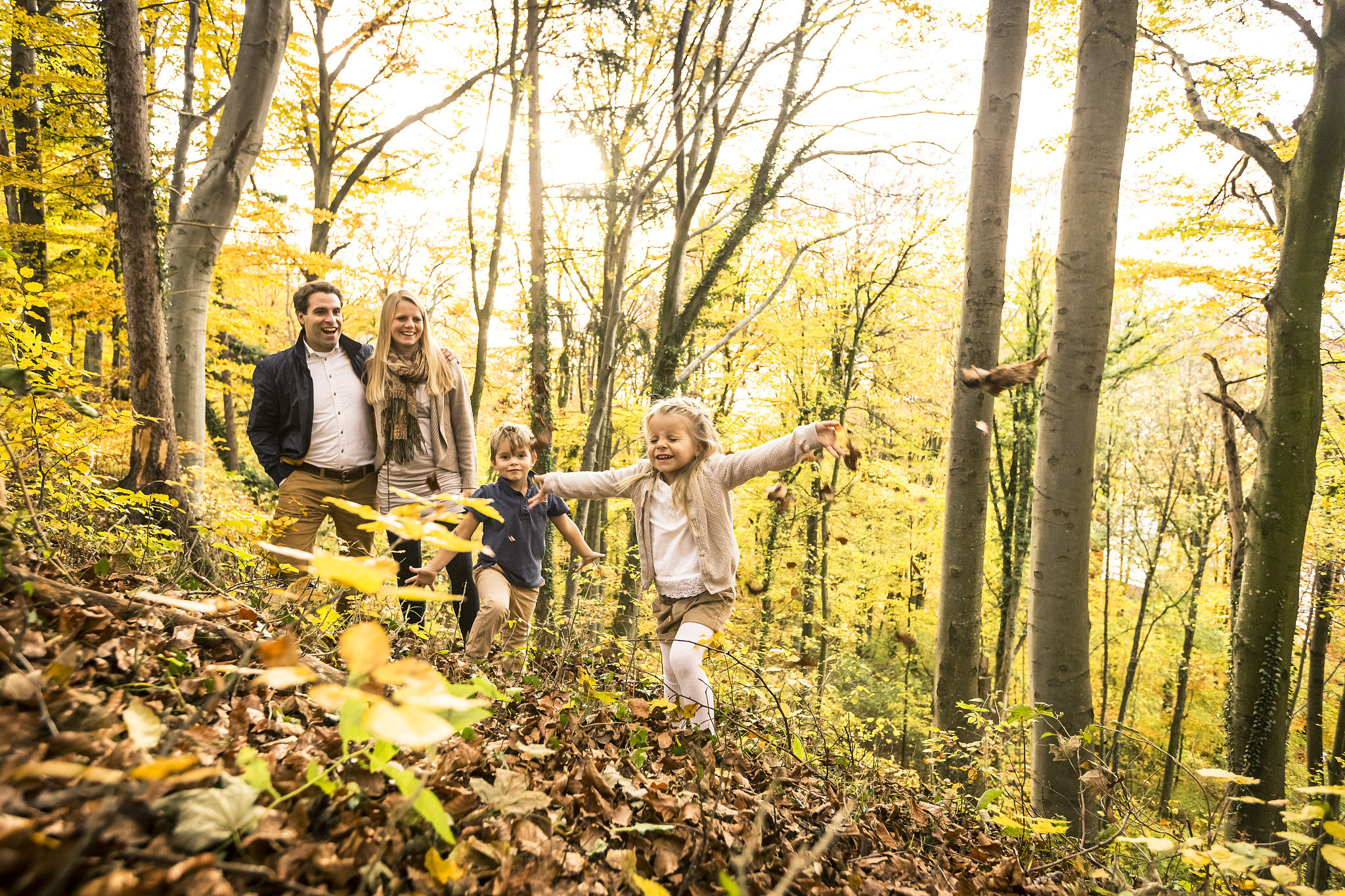 family enjoying autumn in forest