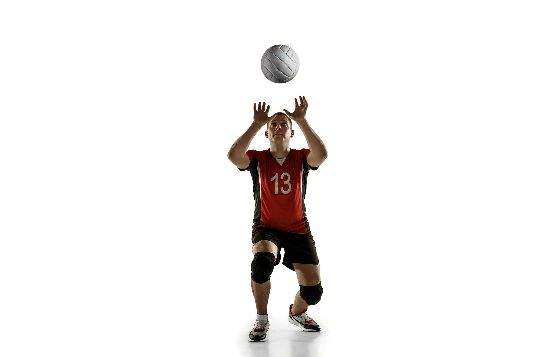 young caucasian volleyball player placticing isolated on white b