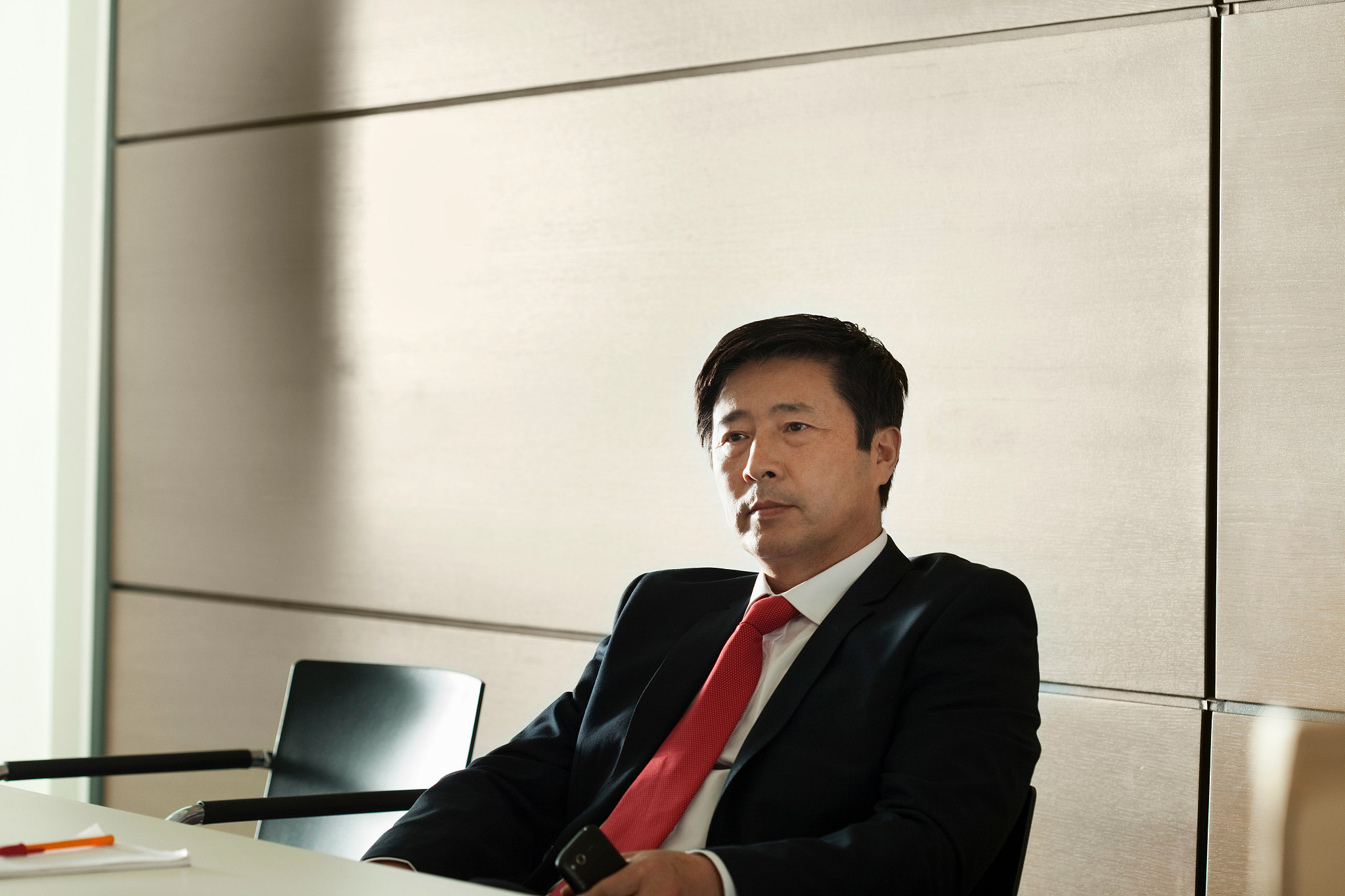 businessman sitting in meeting room, portrait