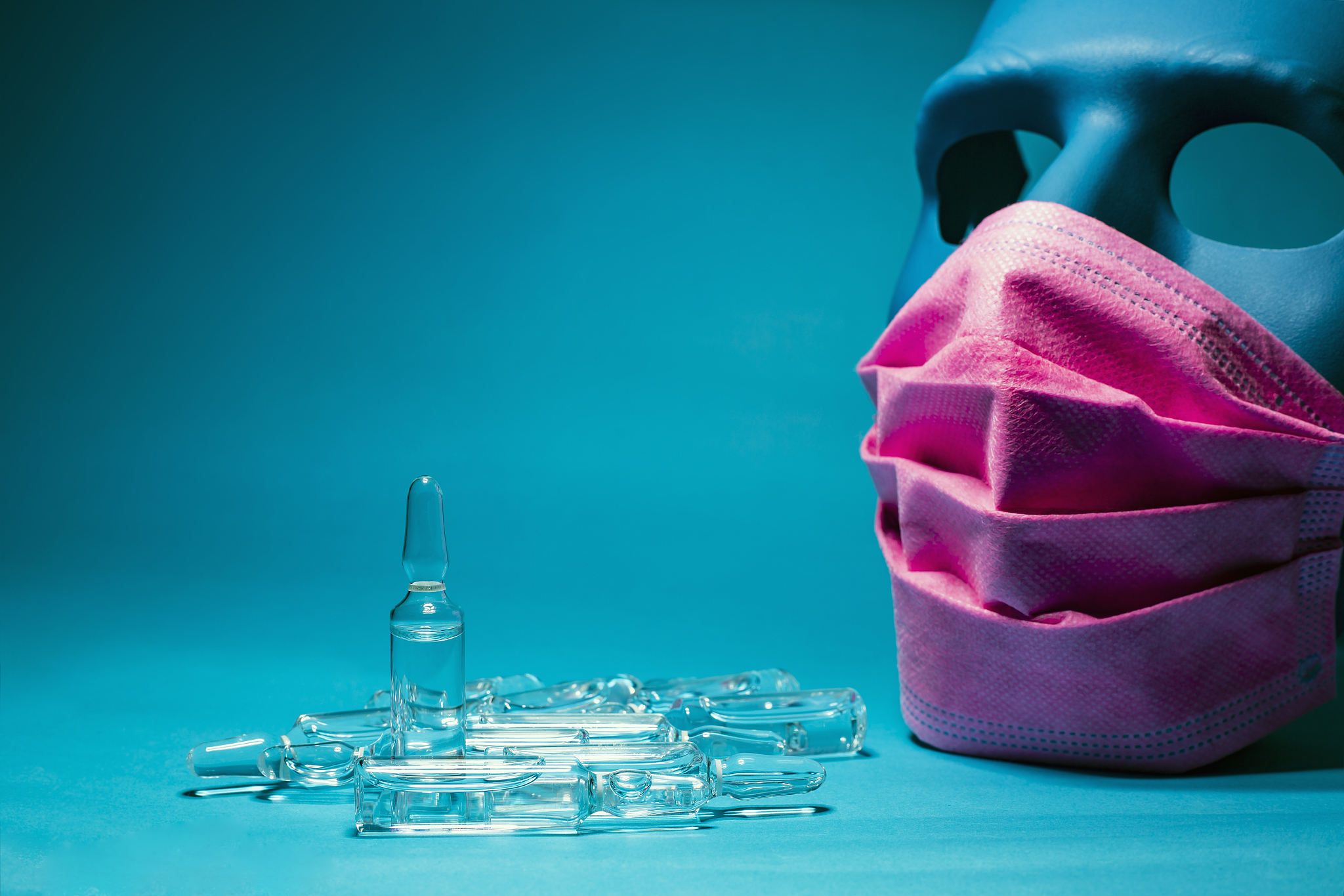 medical pink mask put on a blue mask