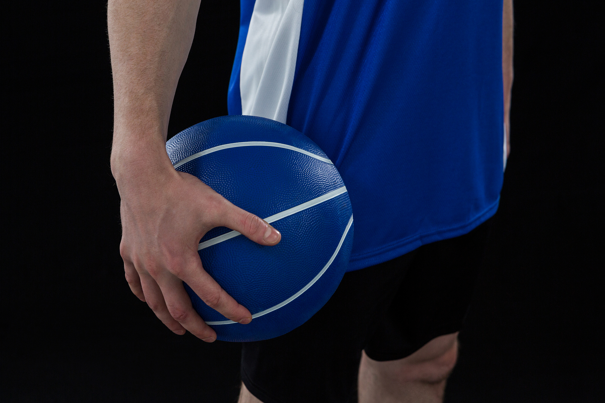 mid section of player holding basketball