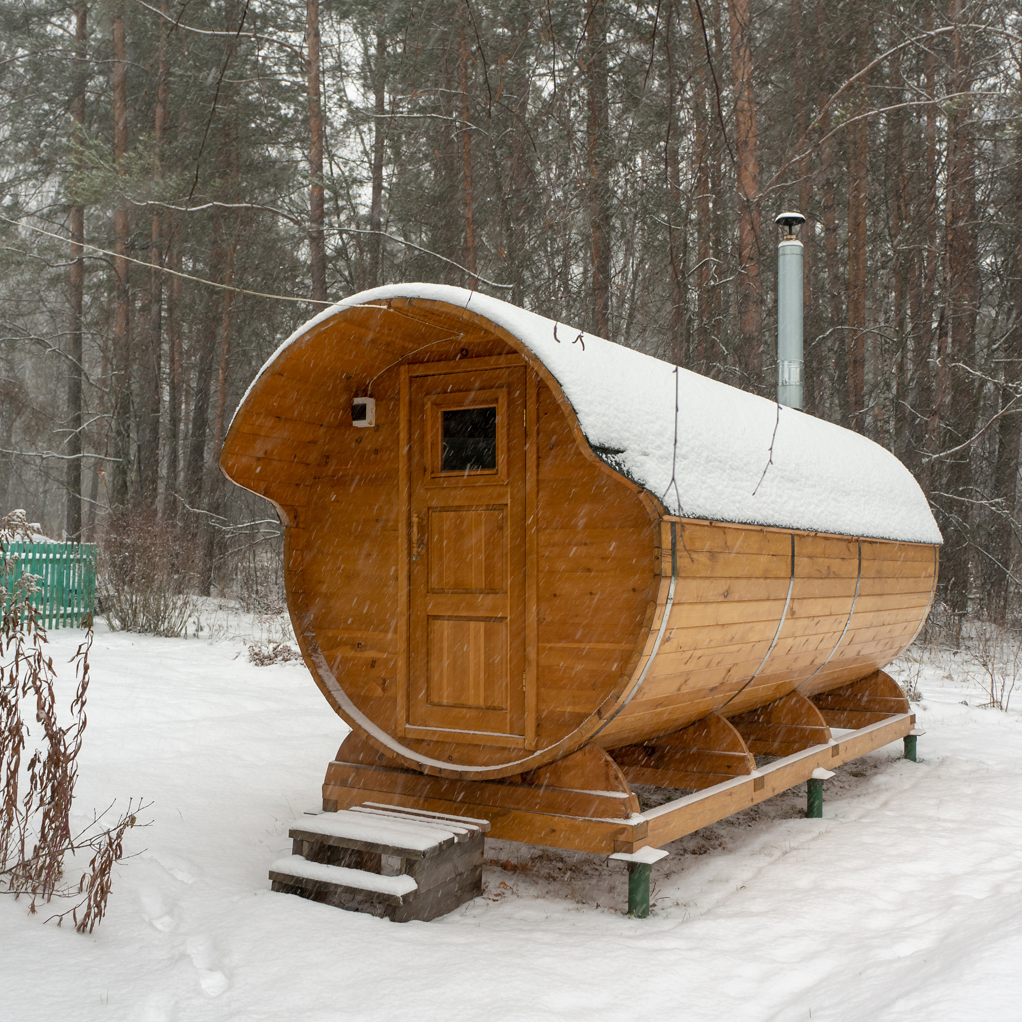 bath barrel on a background of a winter forest. the first snow i
