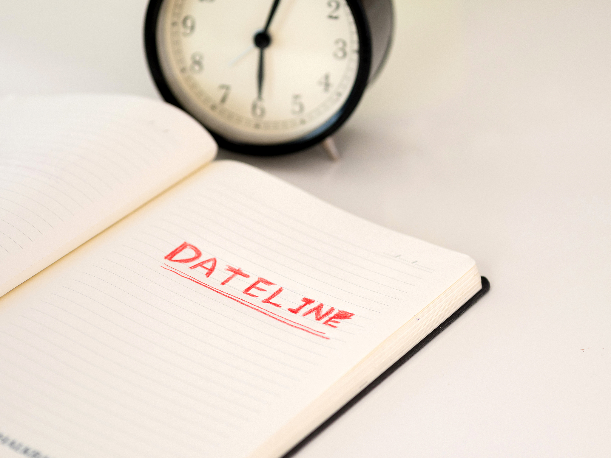 notebook with dateline written with a clock