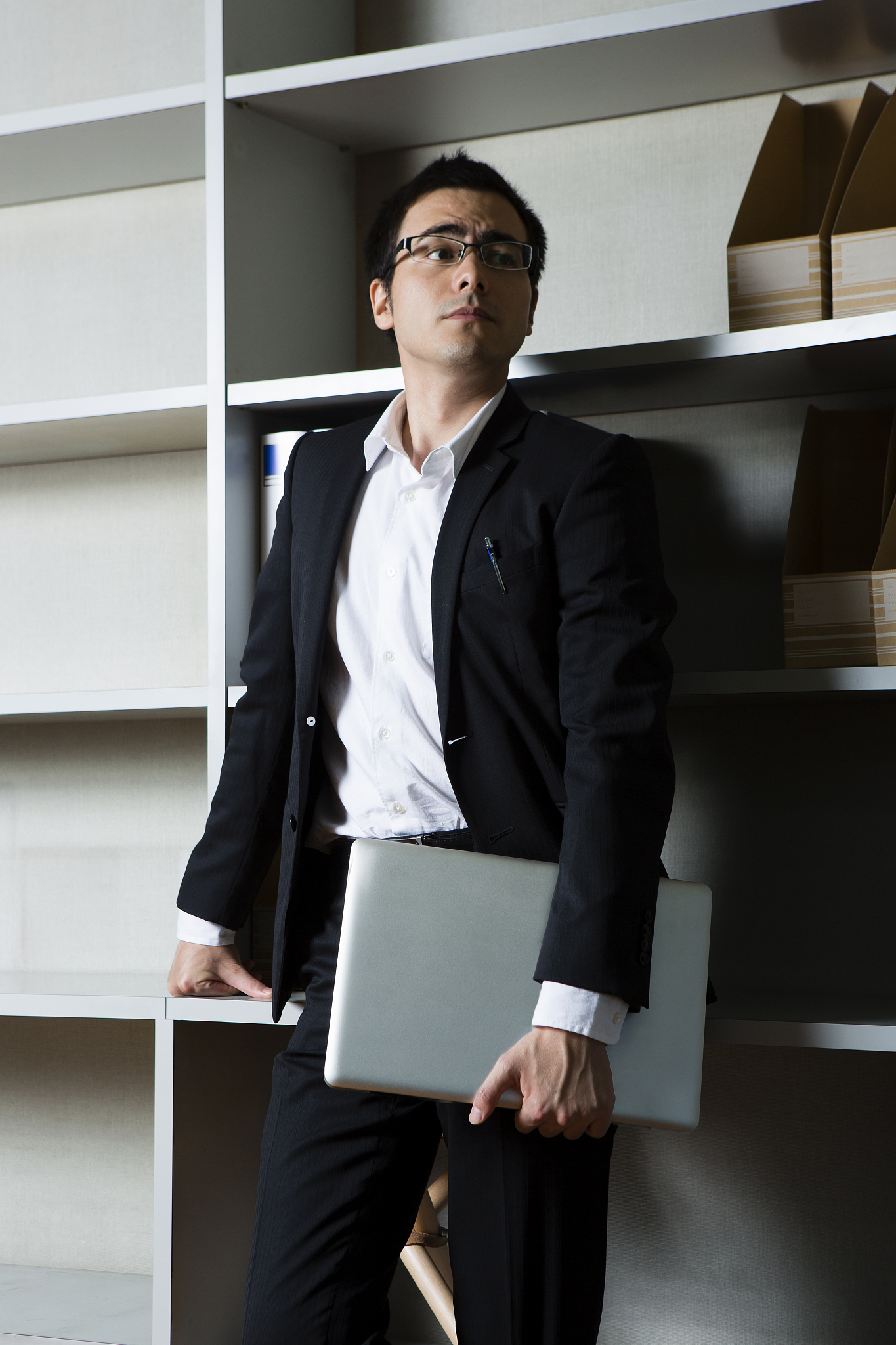 corporate lean against bookshelves
