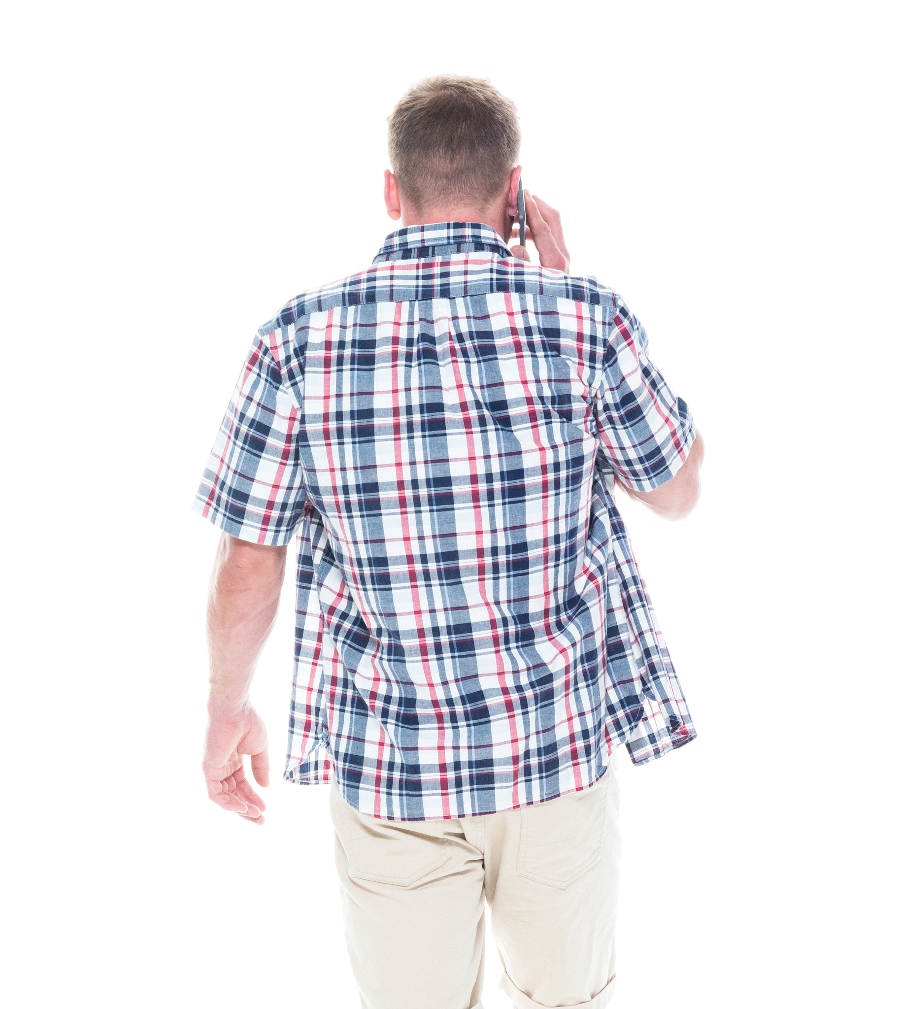 handsome man in shirt and shorts is talking on a phone and walki