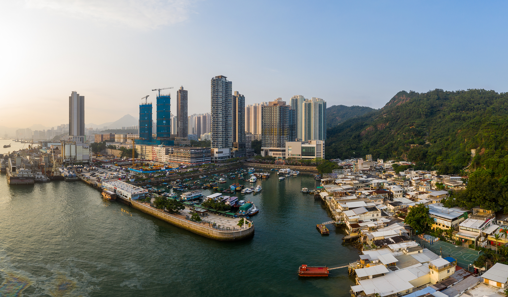 high angle view of harbor by buildings in city against sky