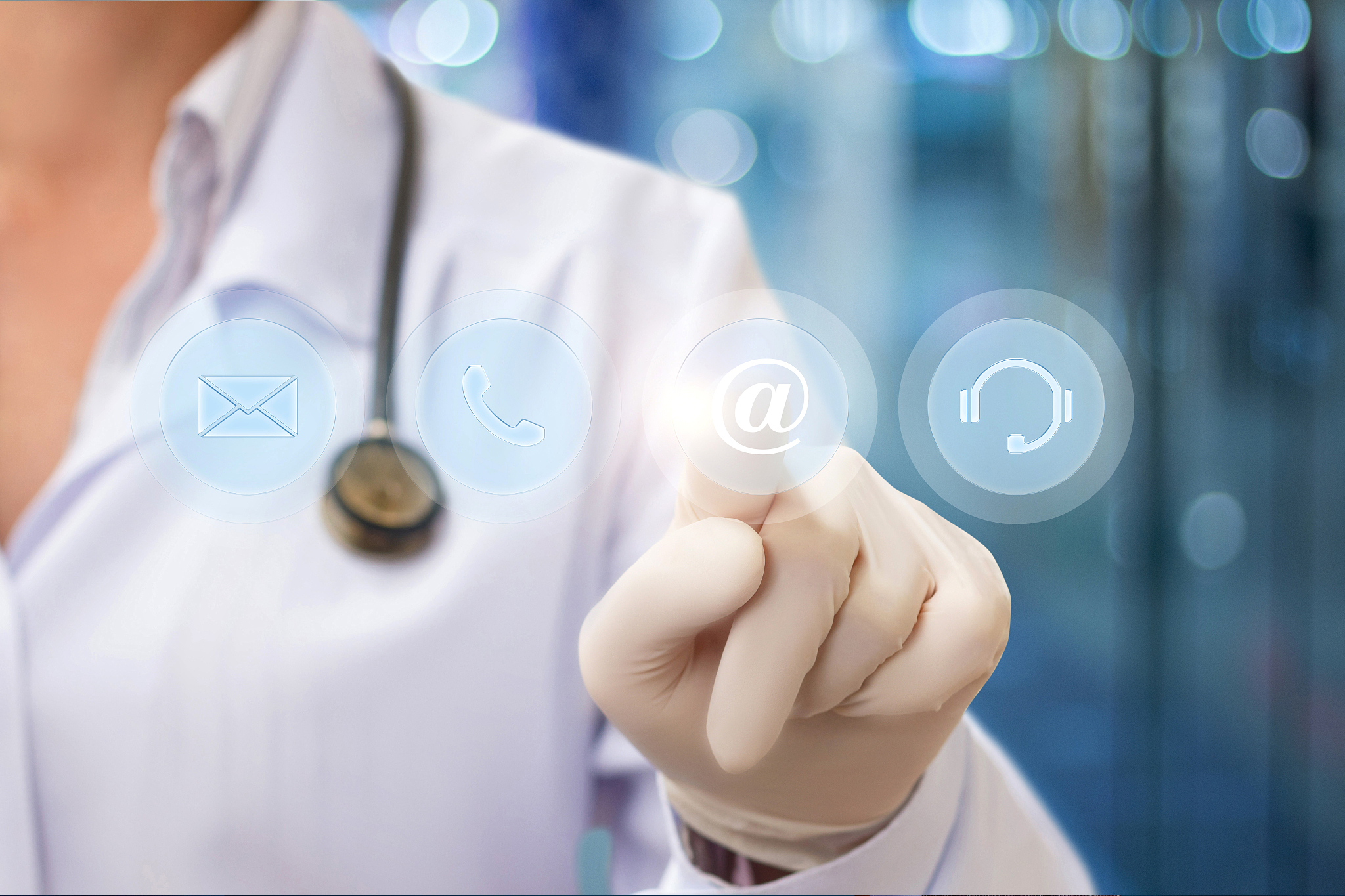 doctor pressing the email button .