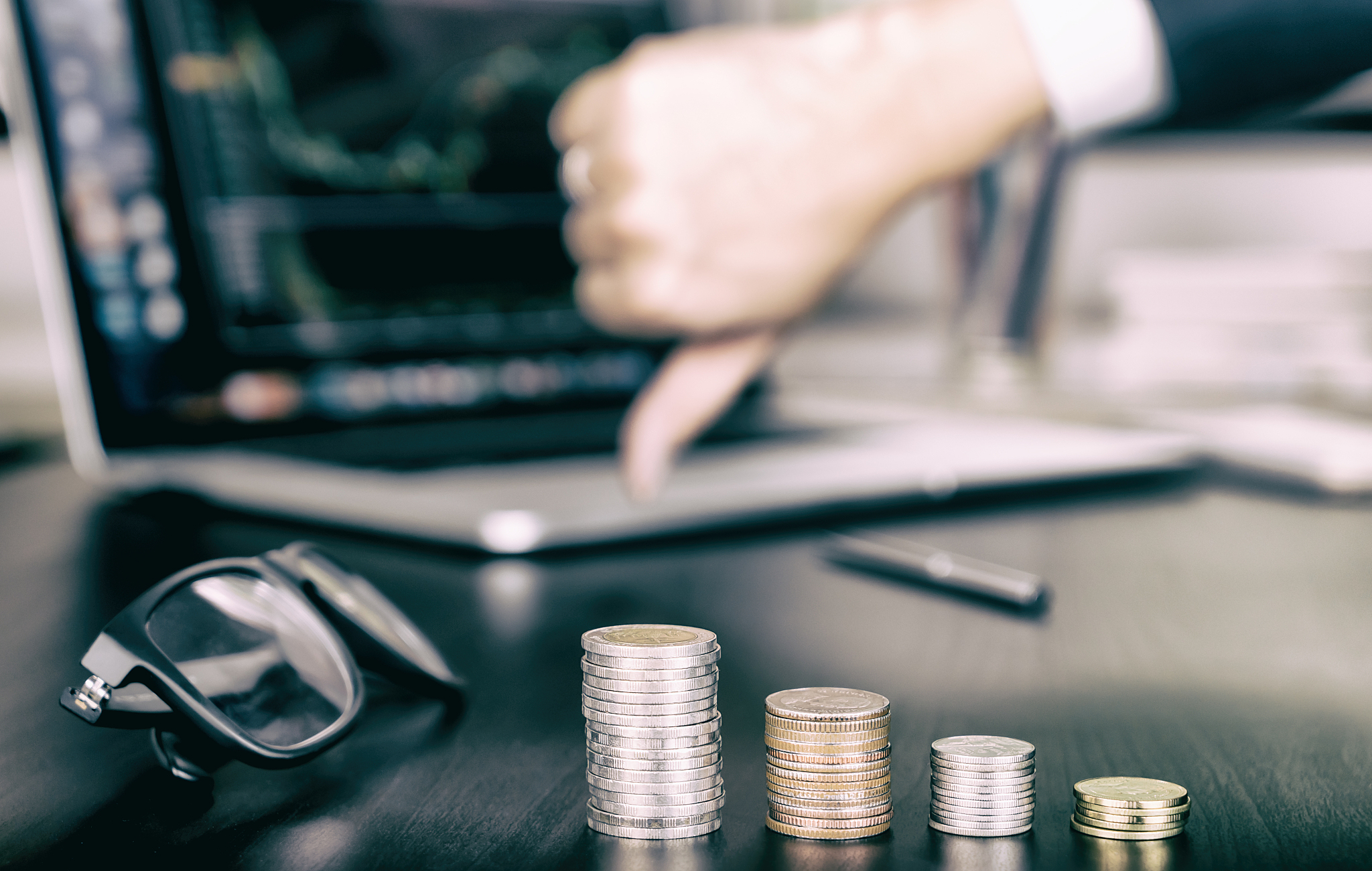coin money stack is going down as business man stock fail, thumb