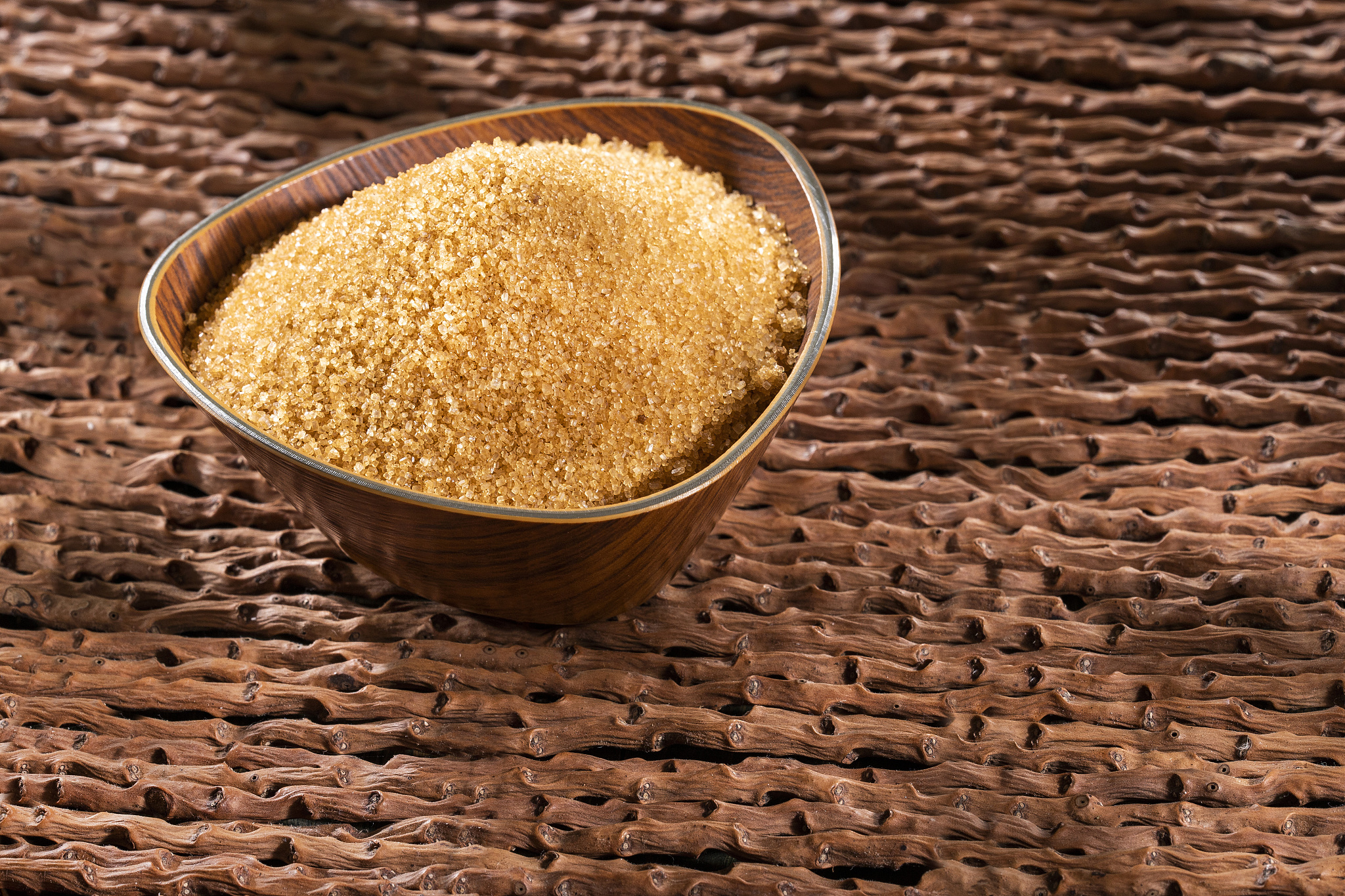 saccharum officinarum - organic brown sugar in the wooden bowl