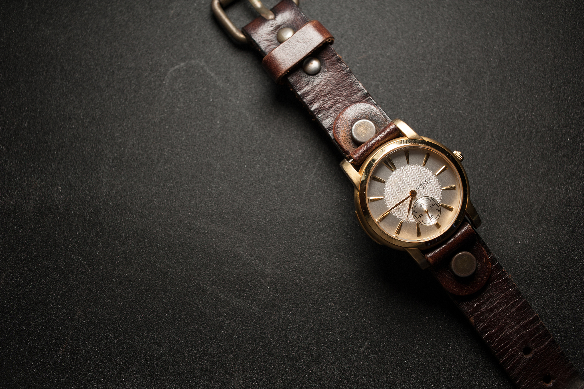 vintage watch on a brown leather wallet. classic wristwatch.