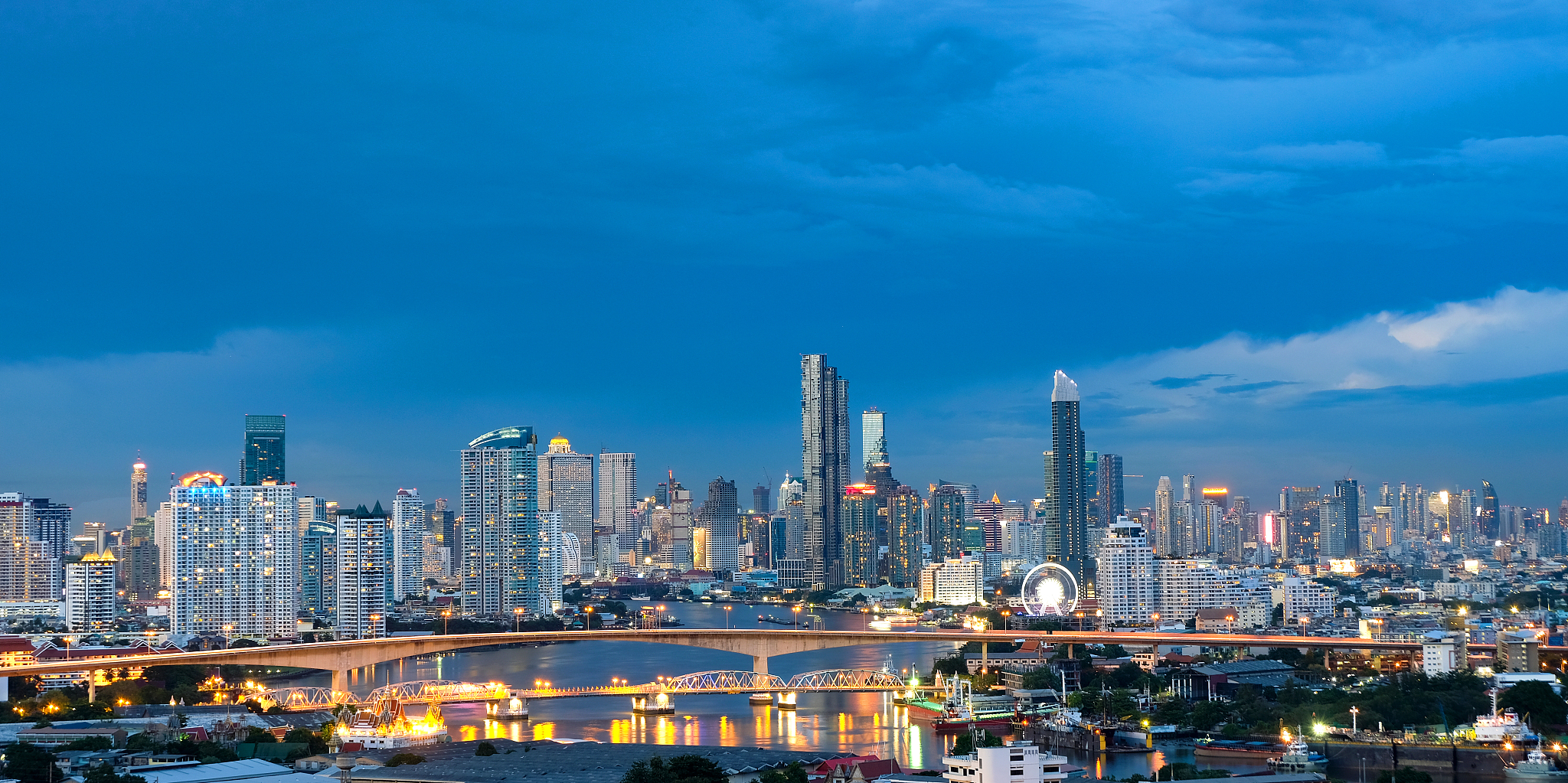 photos of modern city and tall buildings in bangkok in the eveni