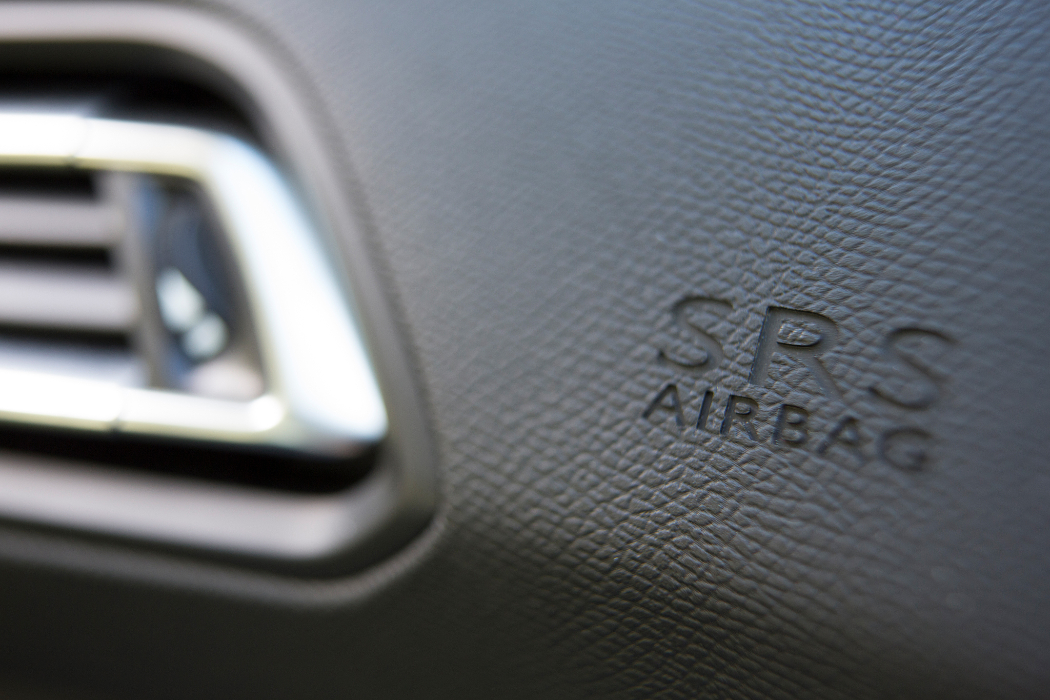 close up of airbag notice on car dashboard