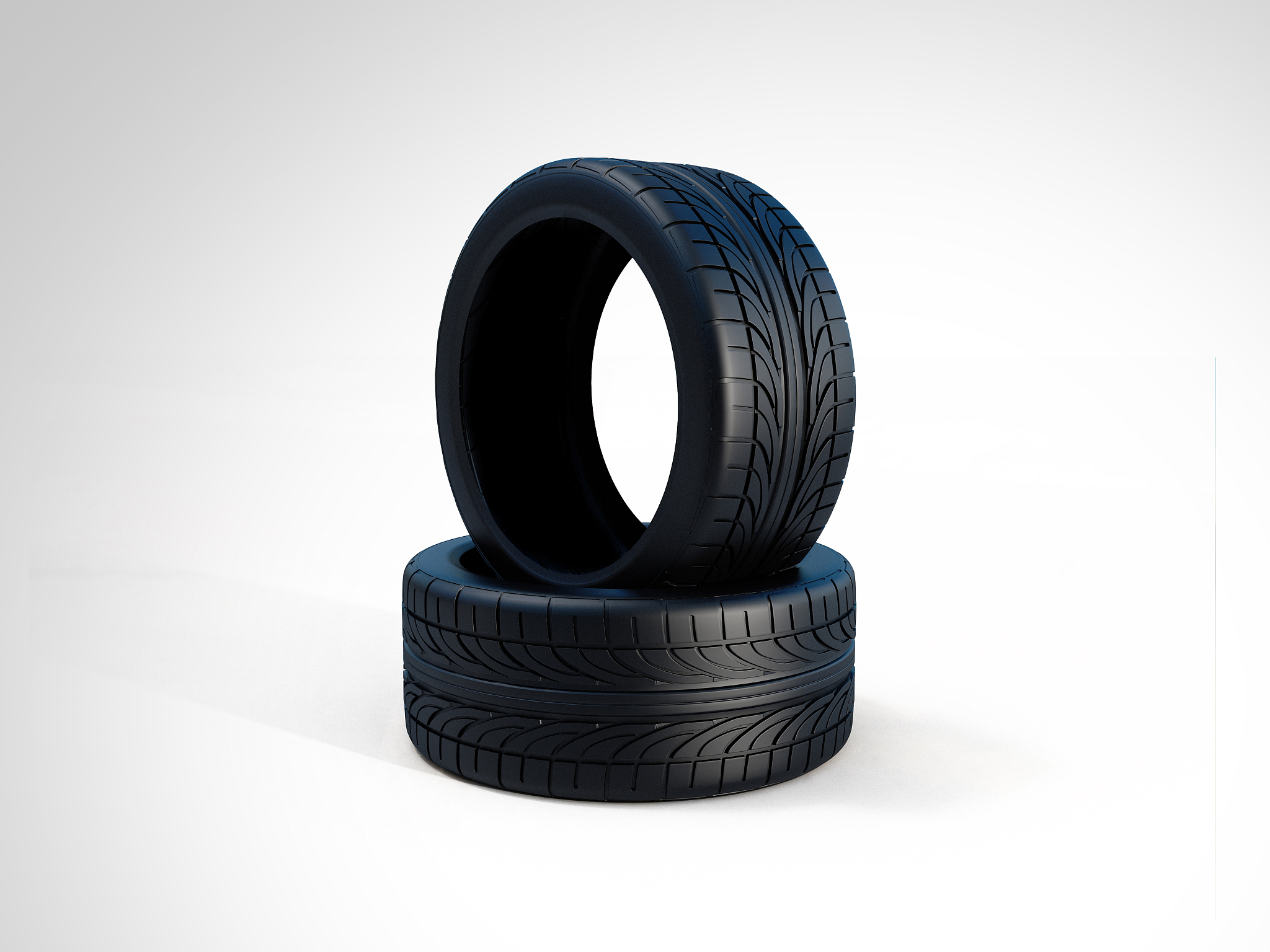 two new car tires on white background.