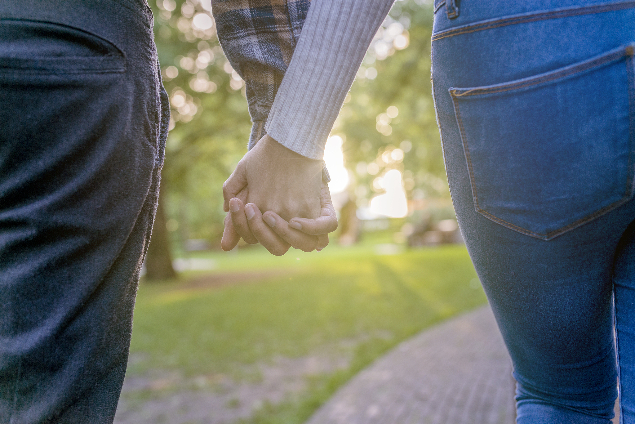 couple standing in a park in london and watching sunset