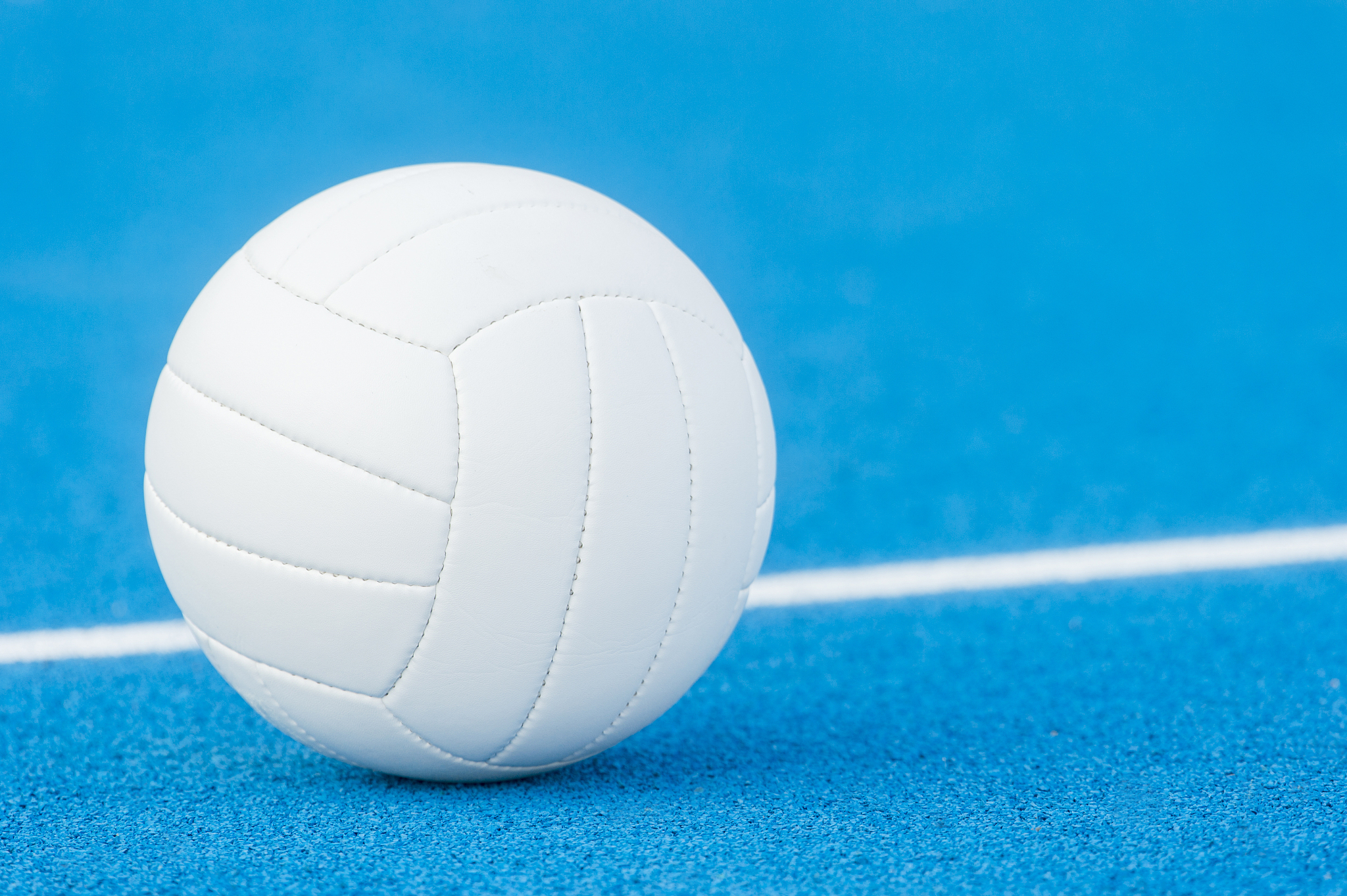 volleyball ball on blue playground with white line