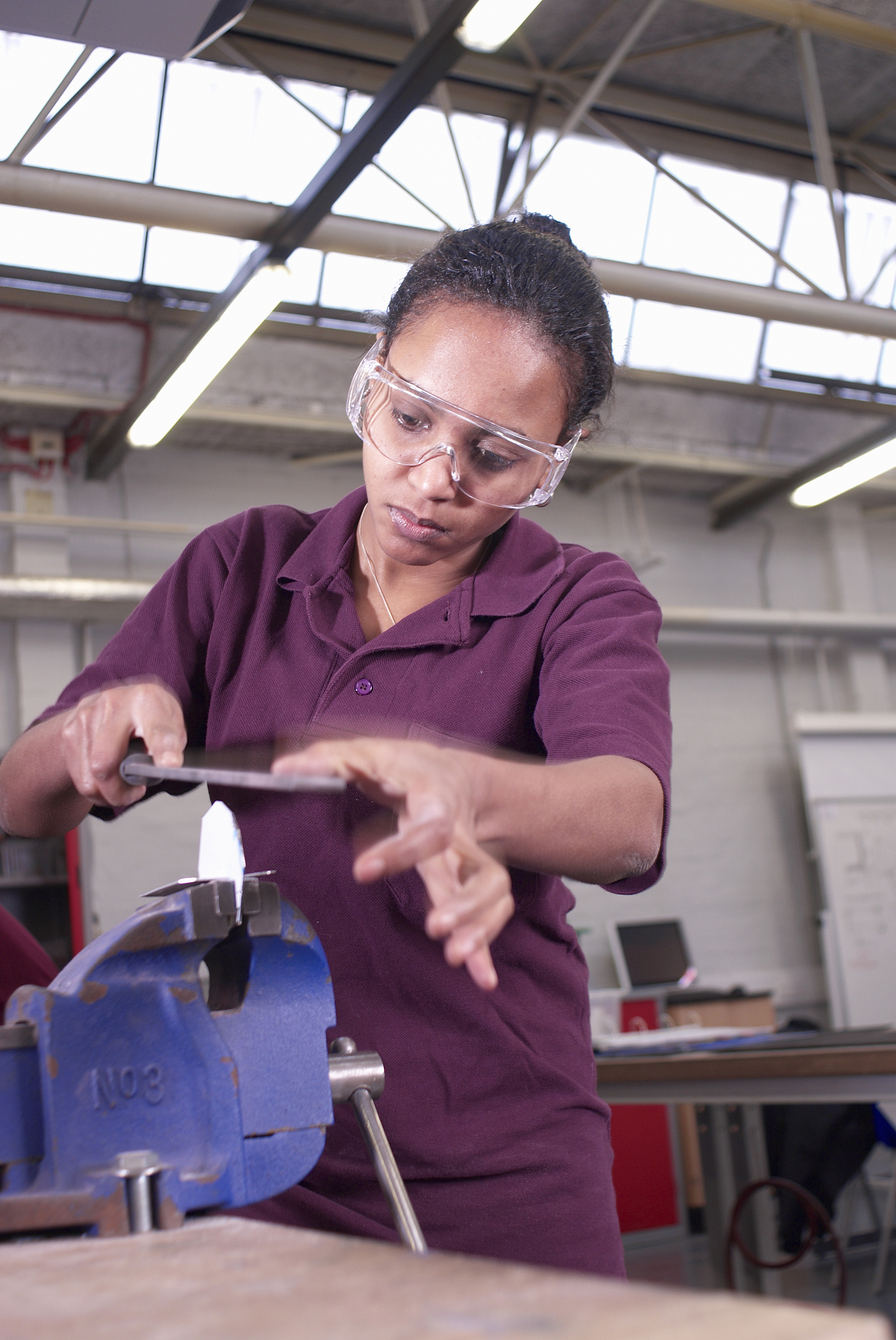 worker using saw in factory