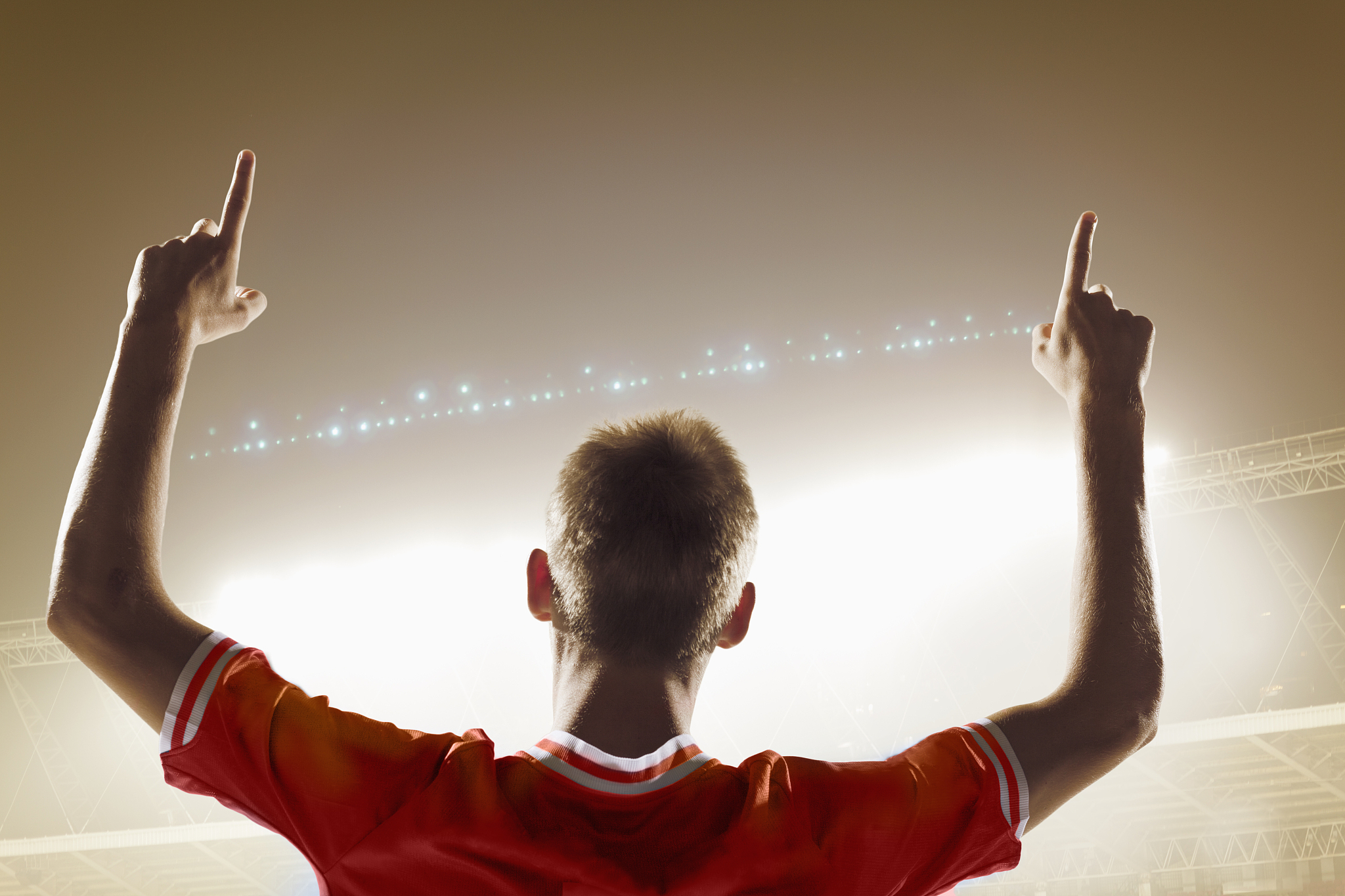 athlete cheering in stadium with number one finger sign