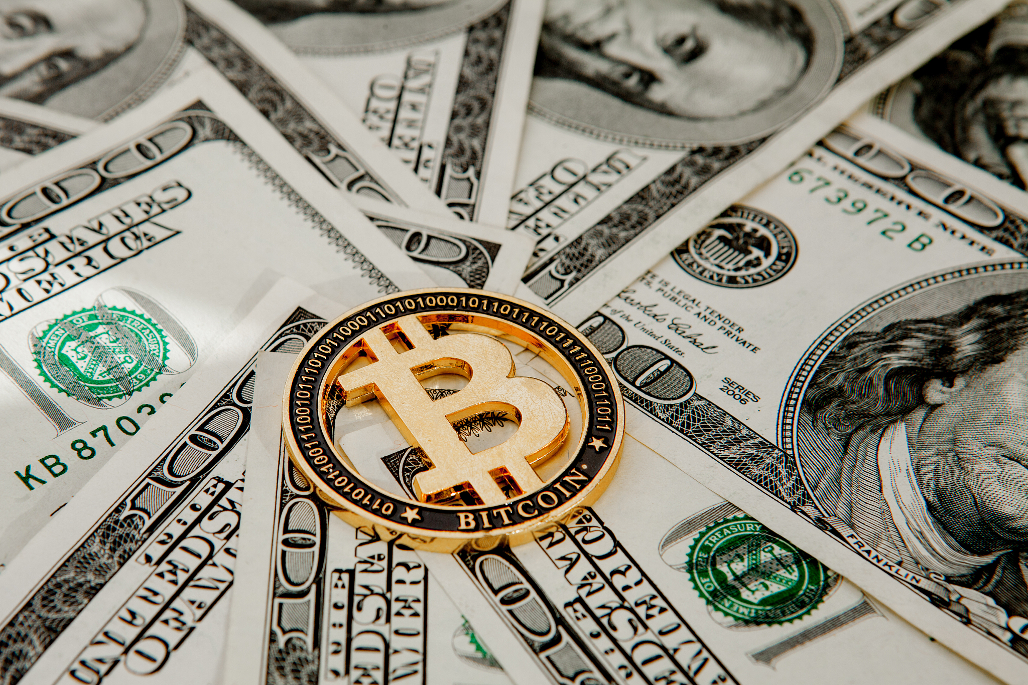 golden bitcoin on us dollar bills. electronic money exchange con