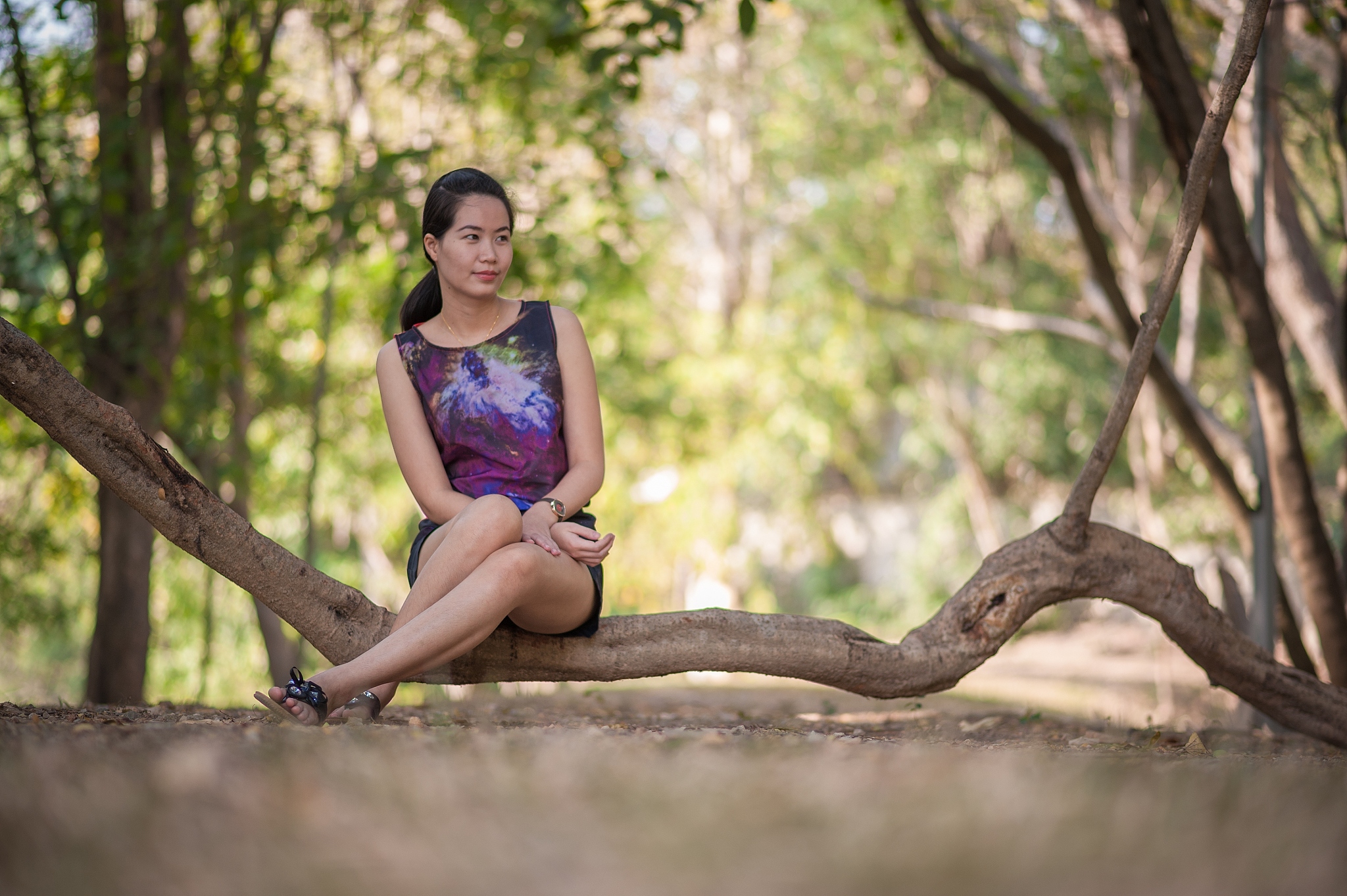 asian woman sitting on the branch.