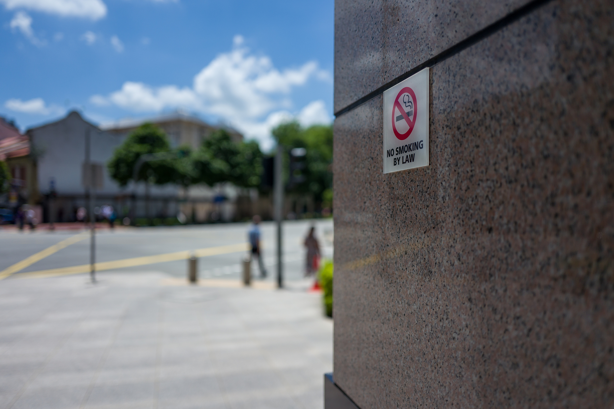 close-up of no smoking sign on wall in city
