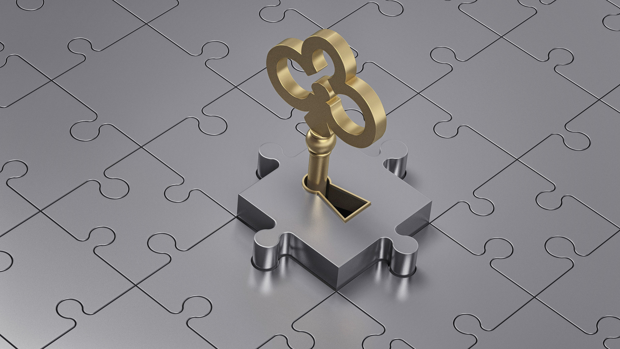 close up of a golden key and metal puzzle.