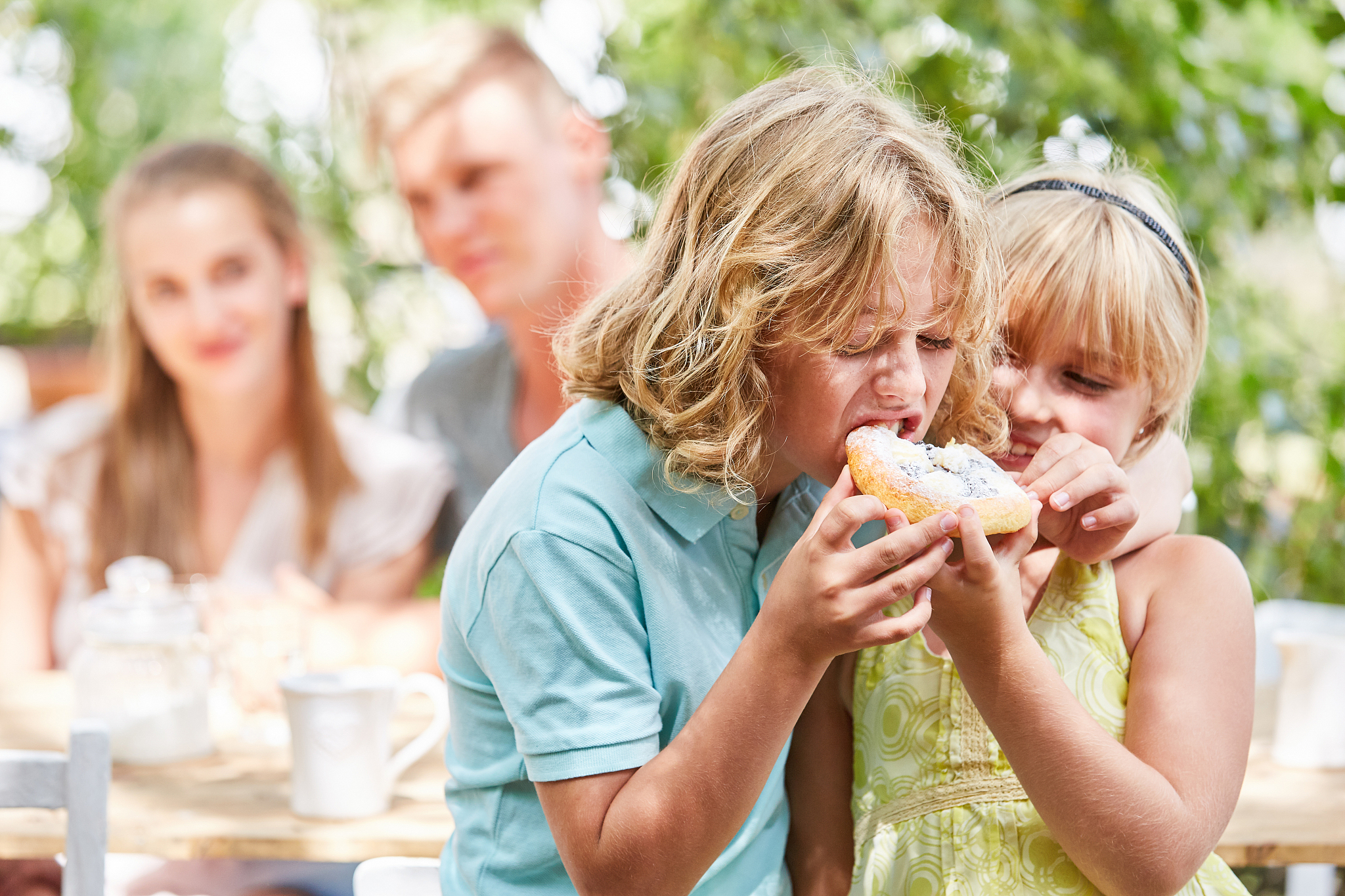 siblings having food at park