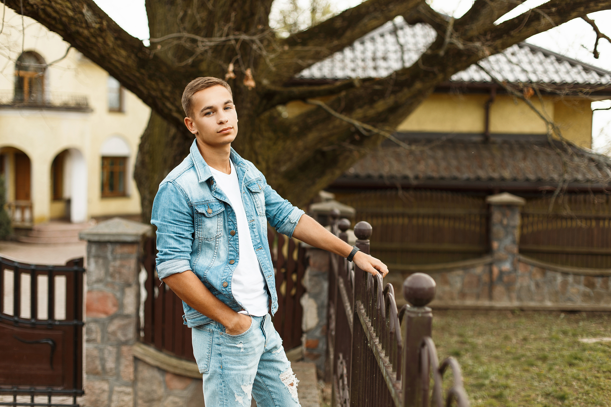 handsome fashionable man in a denim jacket with a white t-shirt 