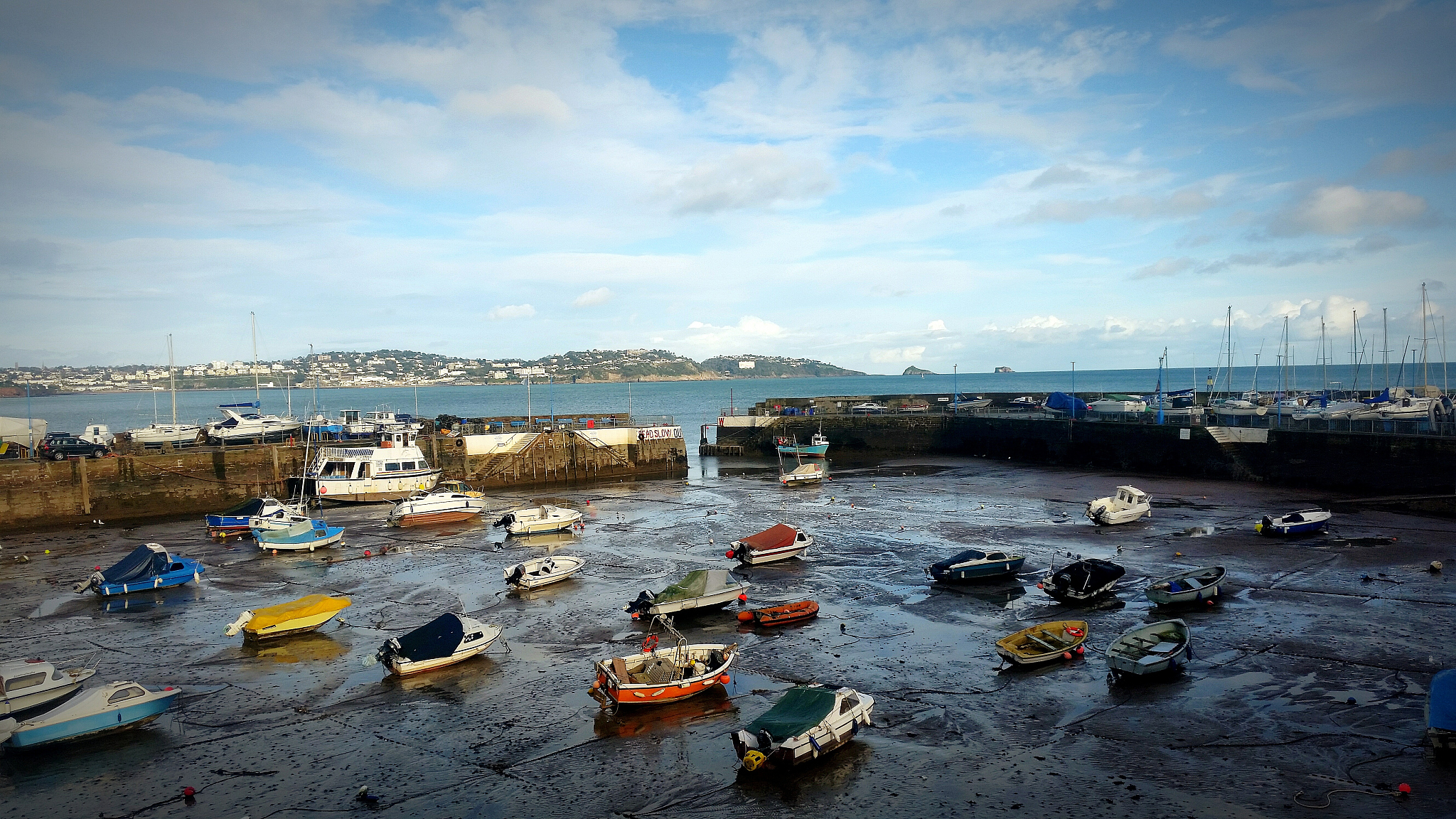 high angle view of boats moored at beach against cloudy sky