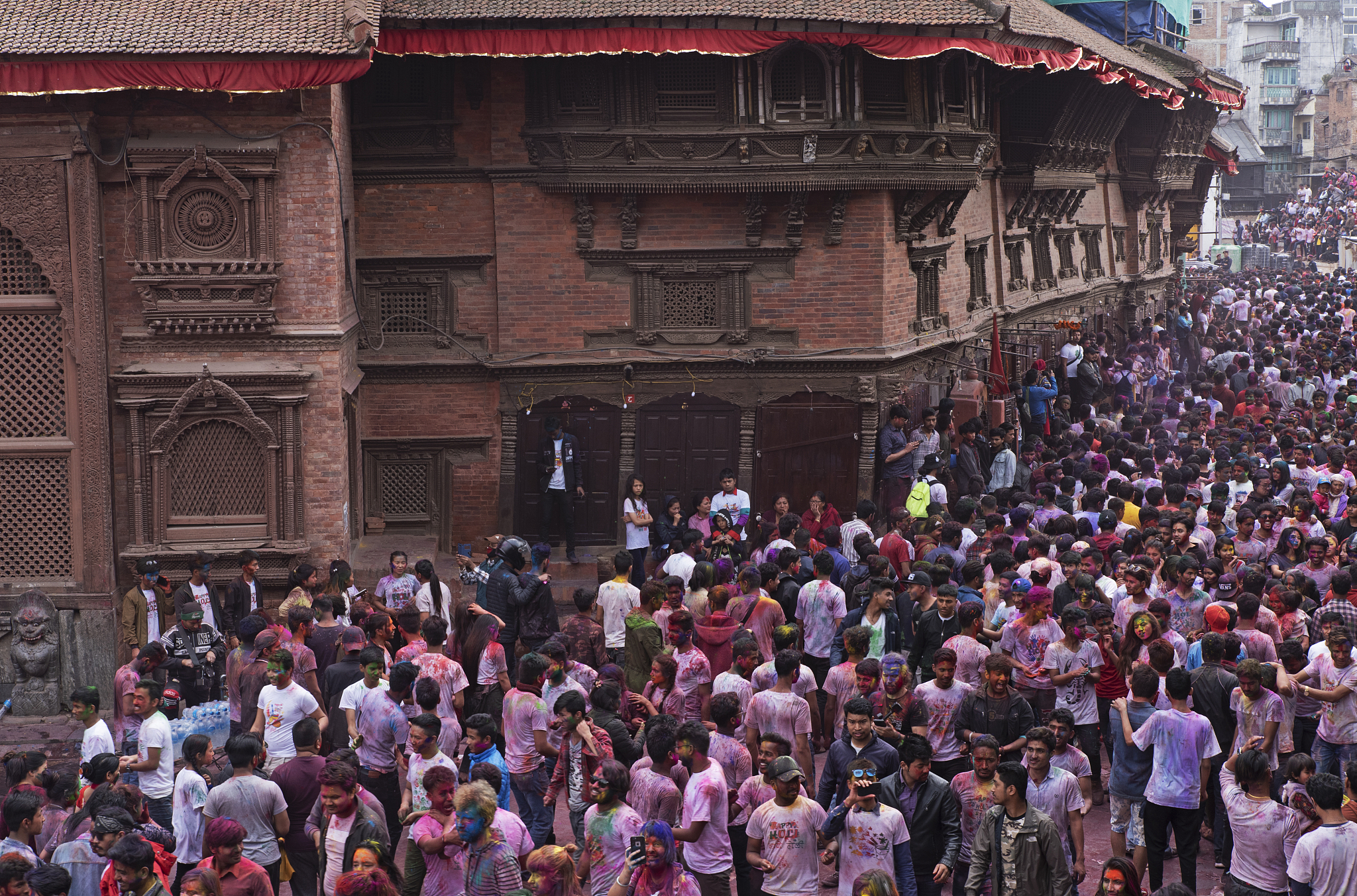 people celebrating holi festival at durbar square, kathmandu