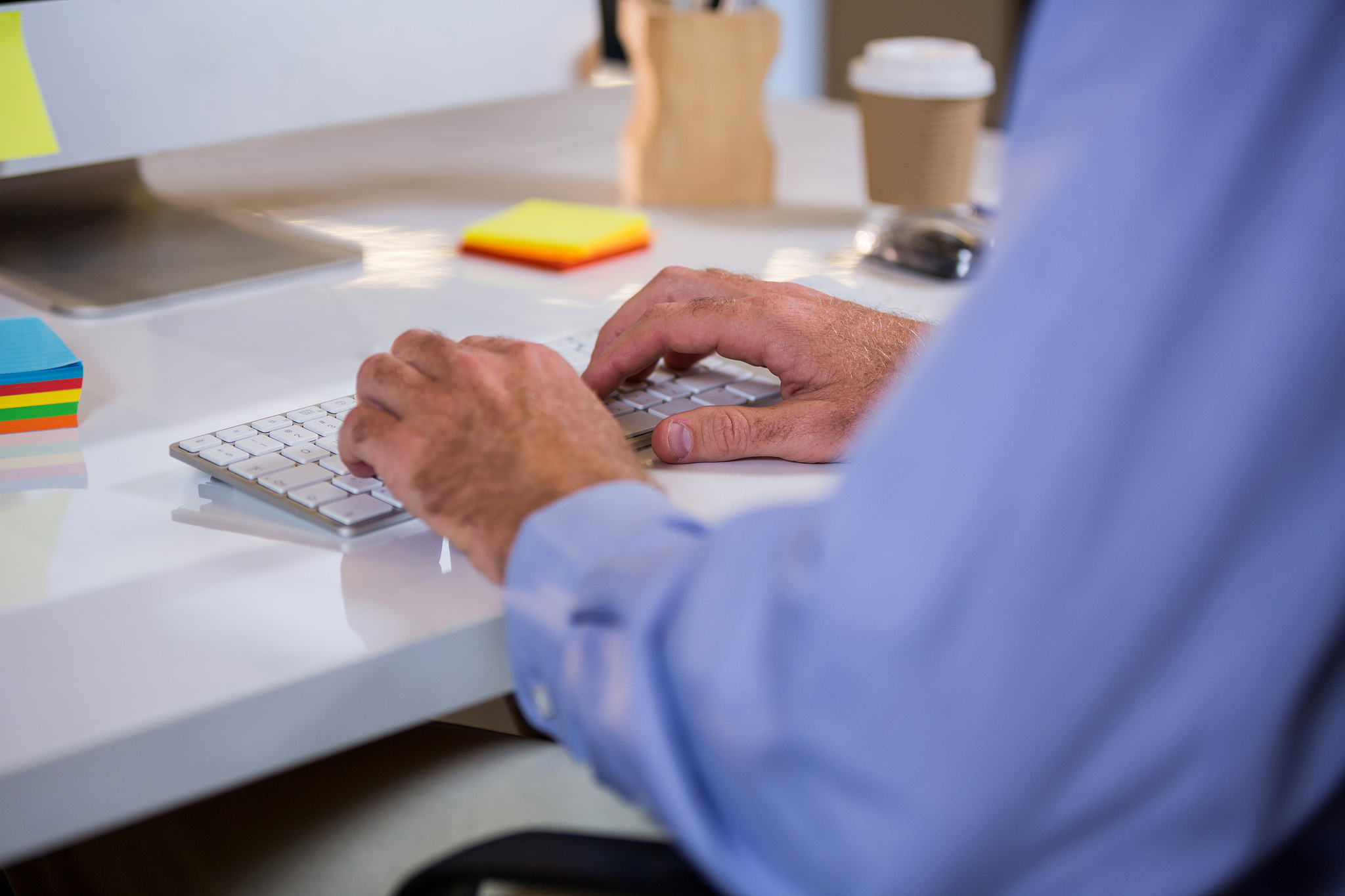 businessman typing on keyboard in office