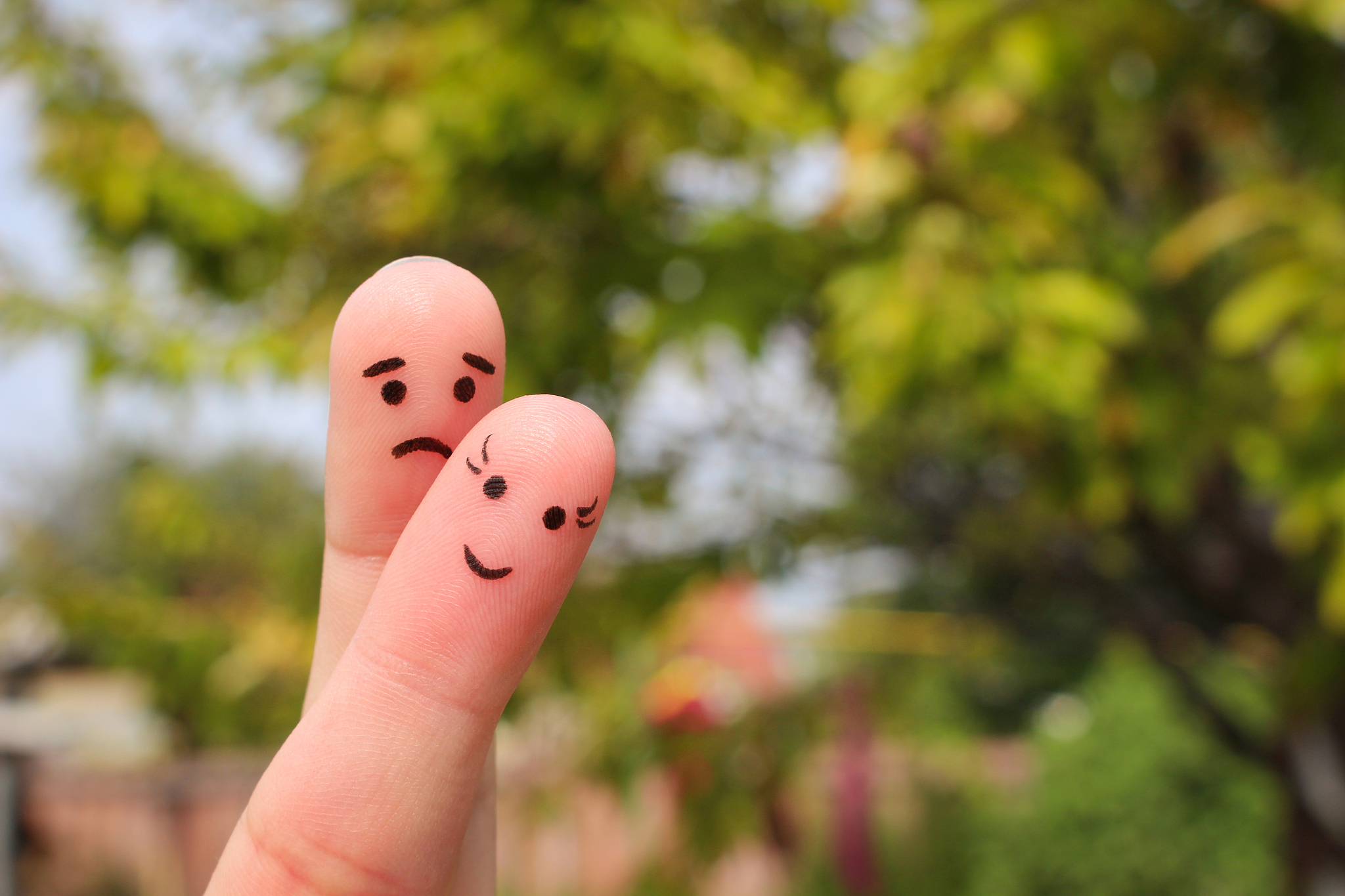 finger art of couple. woman is cheerful, man is sad.