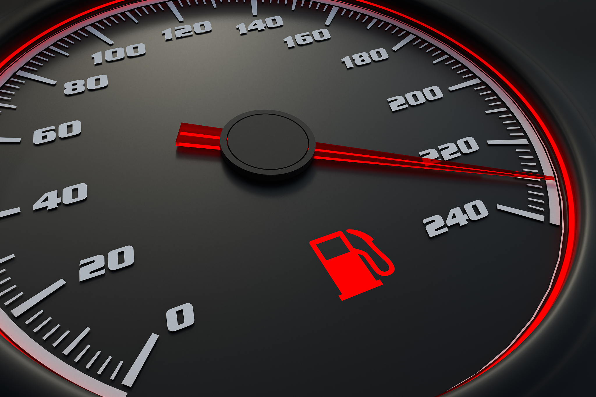 red fuel level light on car dashboard